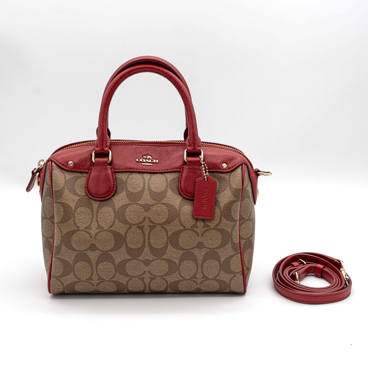 Coach Mini Bennett Boston bag in signature beige canvas with red leather trim, shown with detachable crossbody strap.