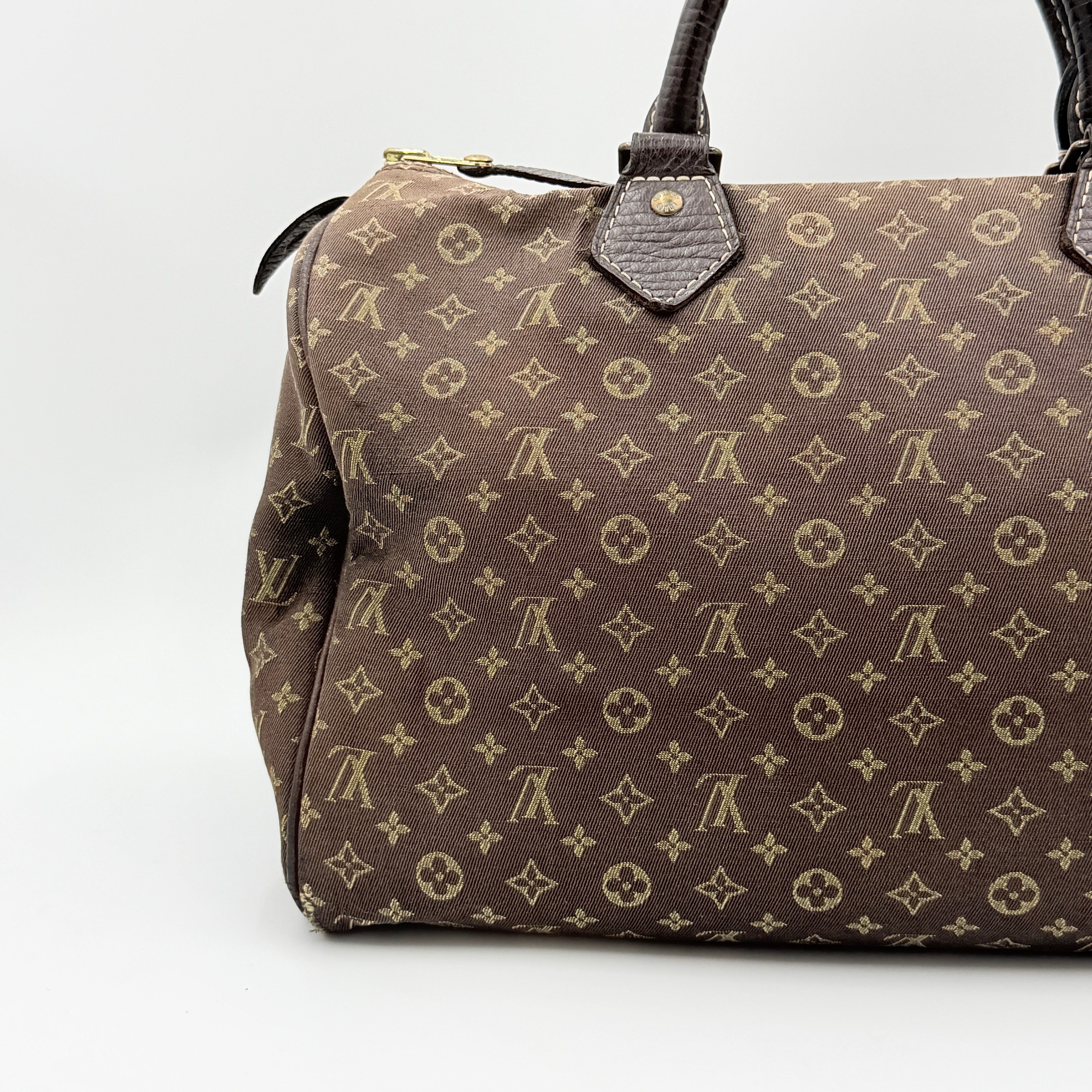 Louis Vuitton Monogram Mini Lin Speedy 30 in brown textile with top handles and monogram motif, shown against a white background.