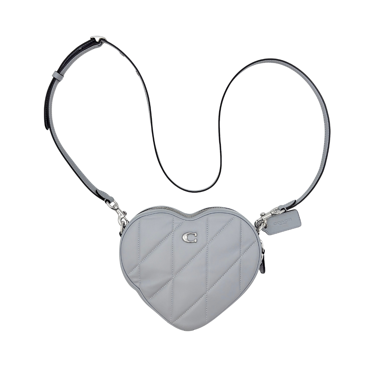 Coach heart-shaped quilted grey crossbody bag with silver hardware and adjustable strap.