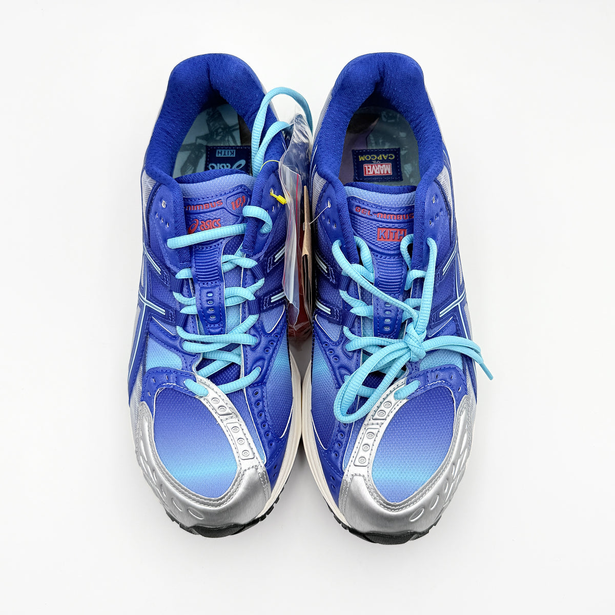 ASICS x KITH Gel-Nimbus 10.1 Mega Man sneakers in bold blue and silver, displayed with extra laces and distinctive collaboration details.
