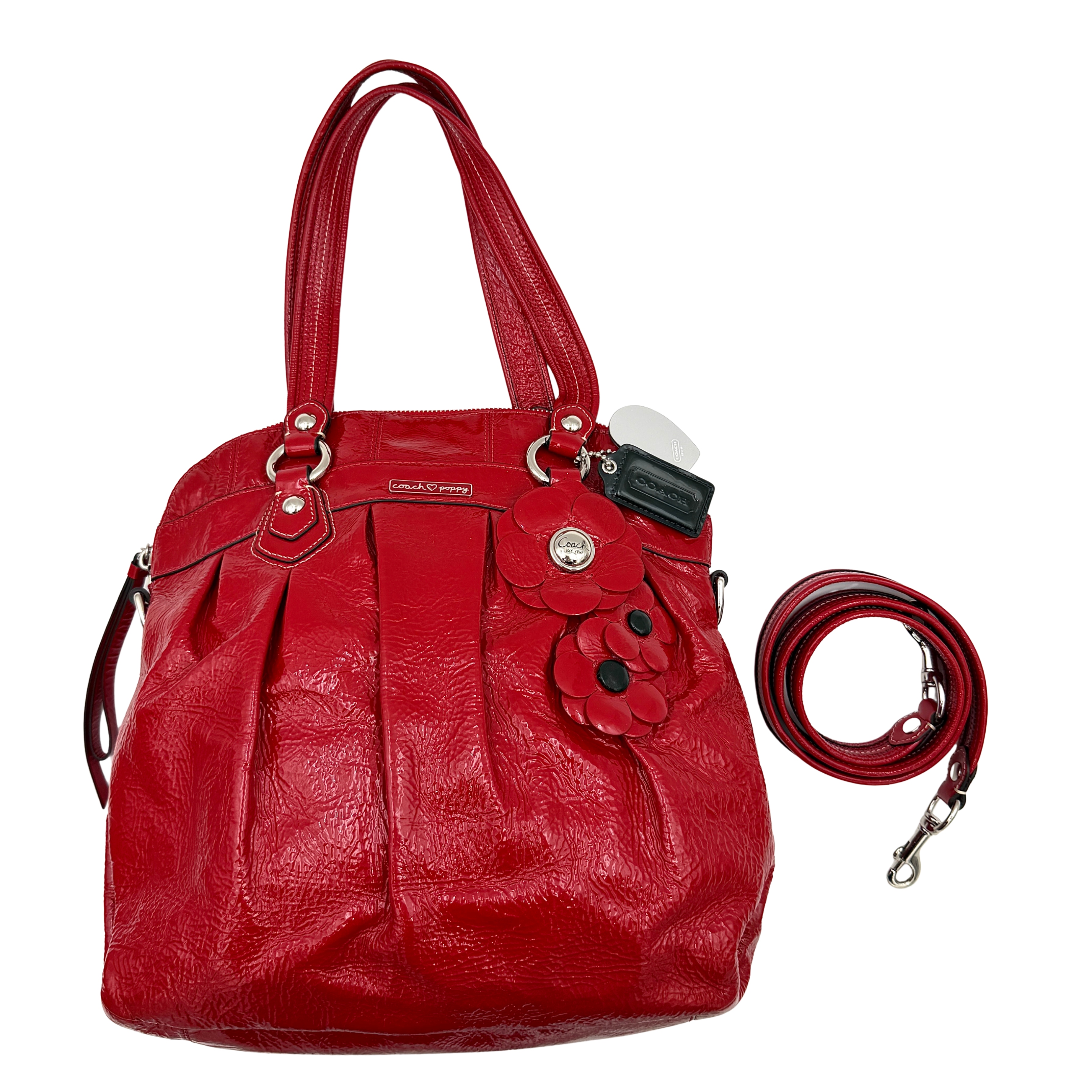 Coach Poppy 2Way shoulder bag in glossy red patent leather with floral appliqué, heart charm, double handles and detachable long strap.