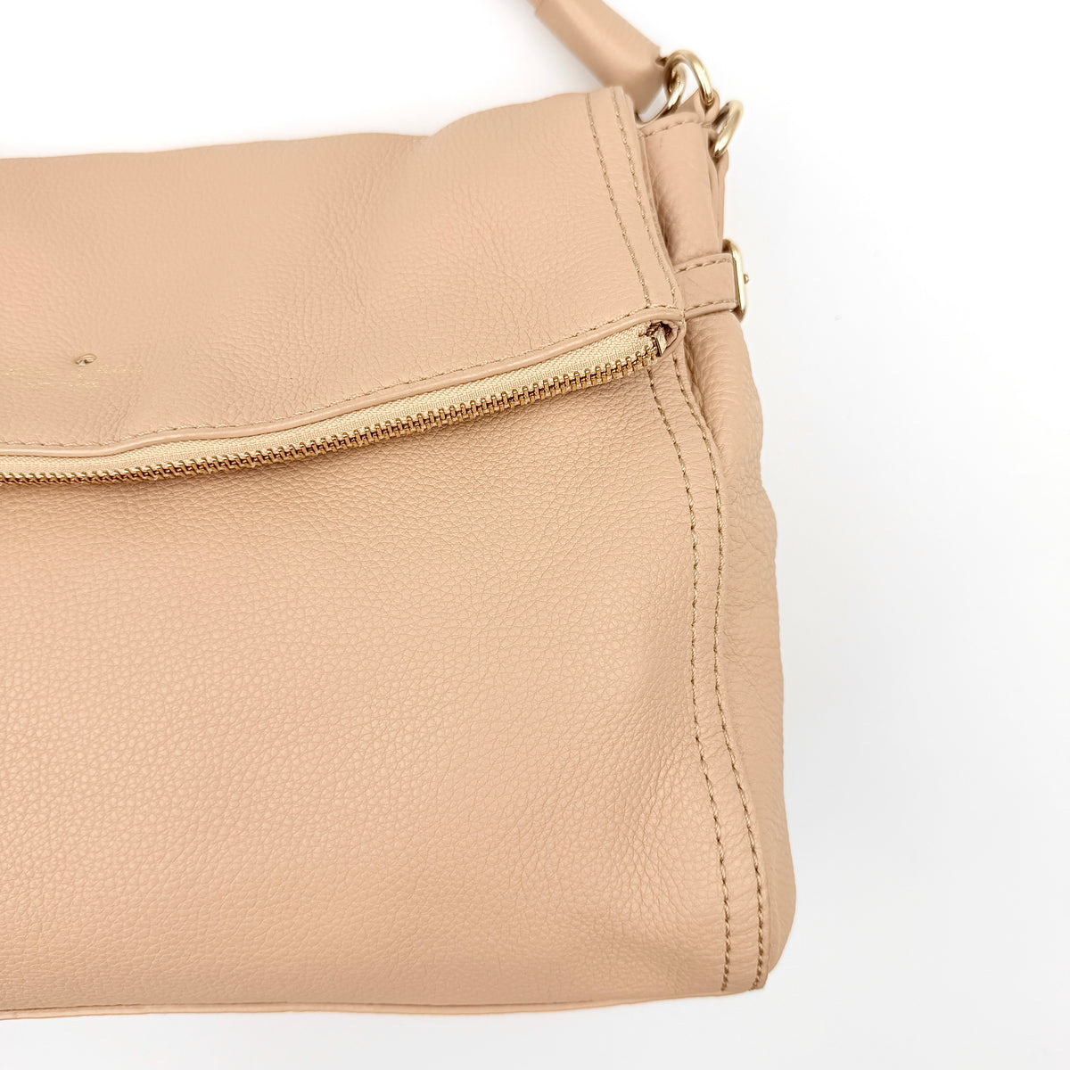 Kate Spade Cobble Hill Little Minka in beige pebbled leather with both top handle and detachable strap displayed.