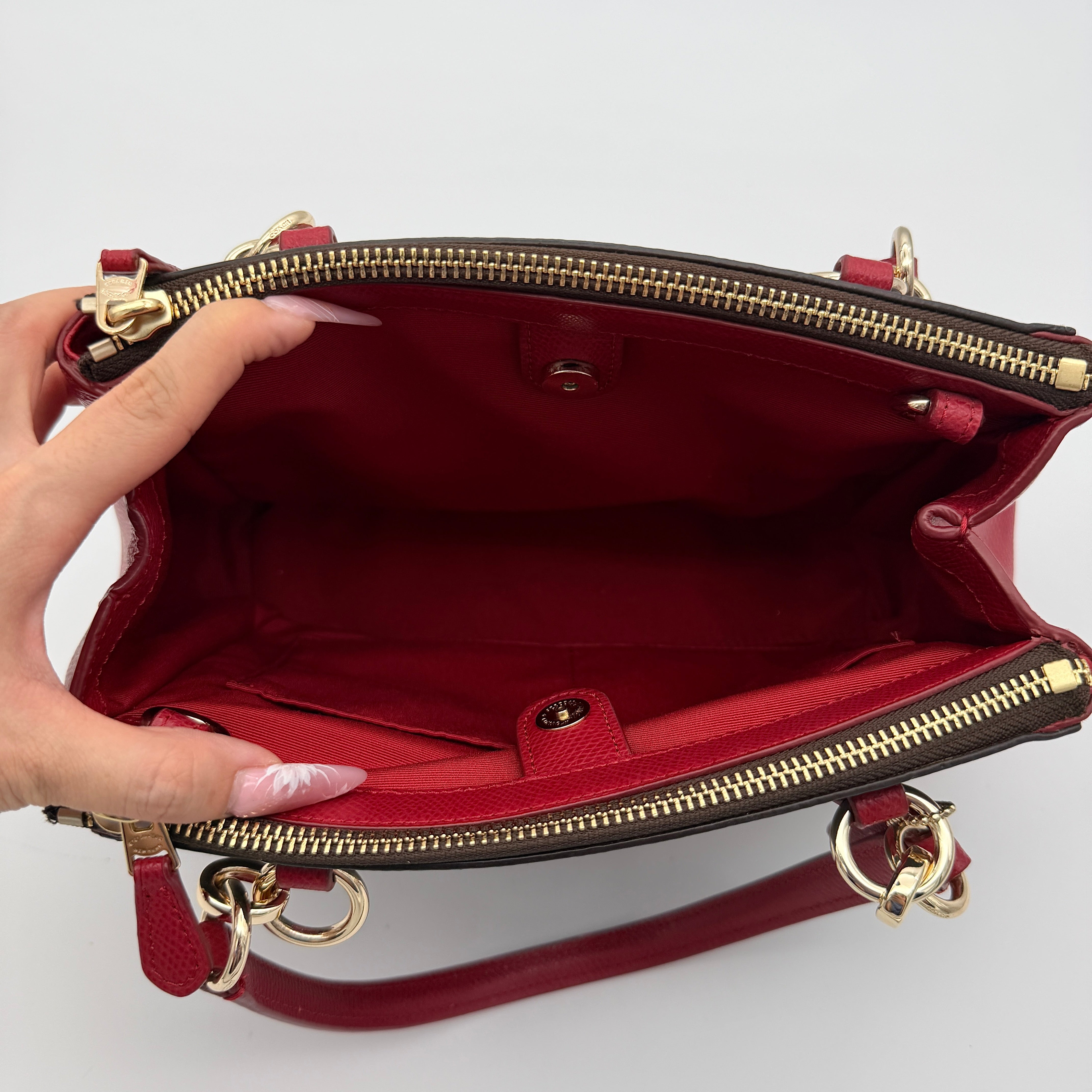 Coach 2Way Christie Carryall in brown coated canvas with red leather handles and sides, gold hardware, shown with detachable strap.