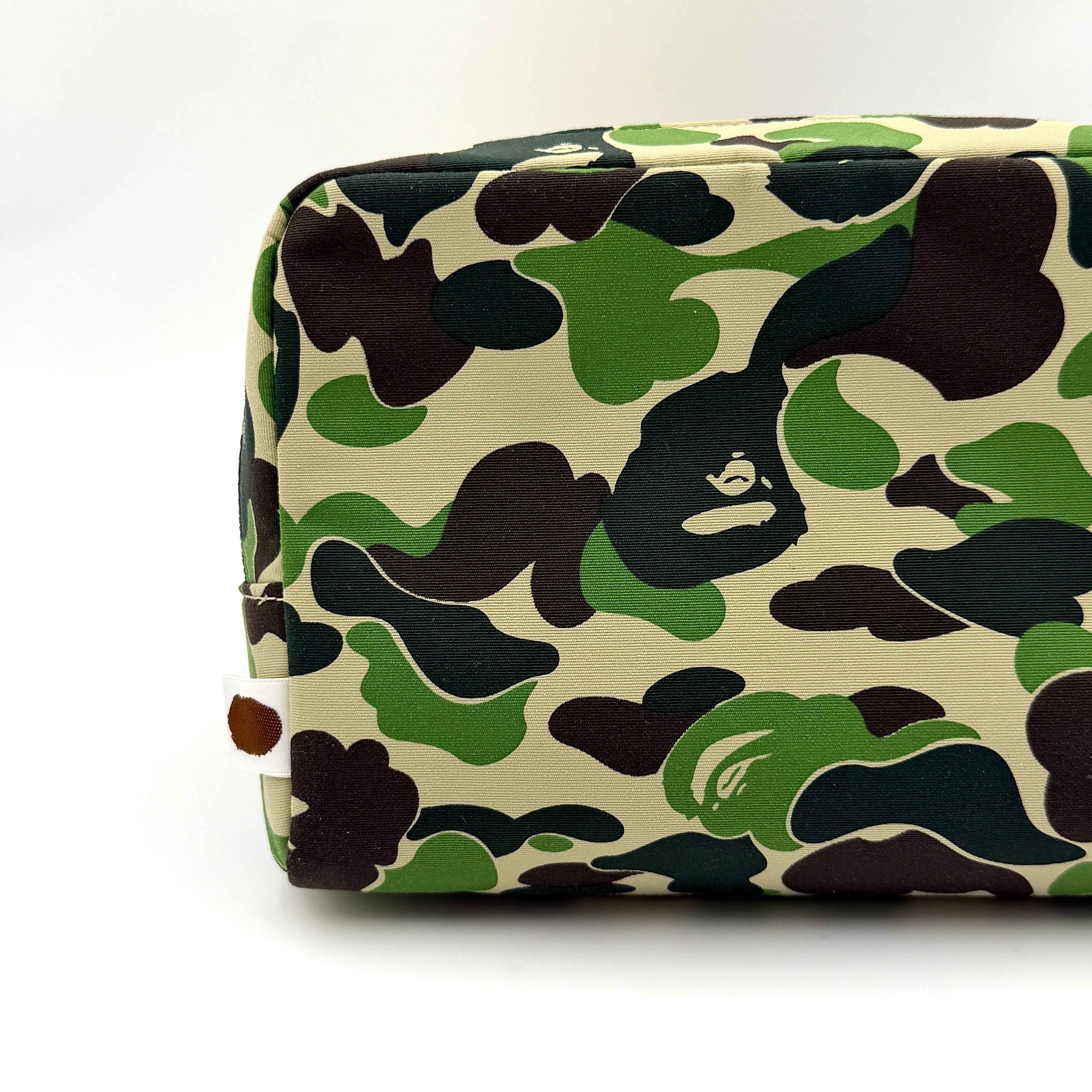 BAPE ABC Camo Pouch in green camouflage with mesh front pocket and embroidered A Bathing Ape logo.