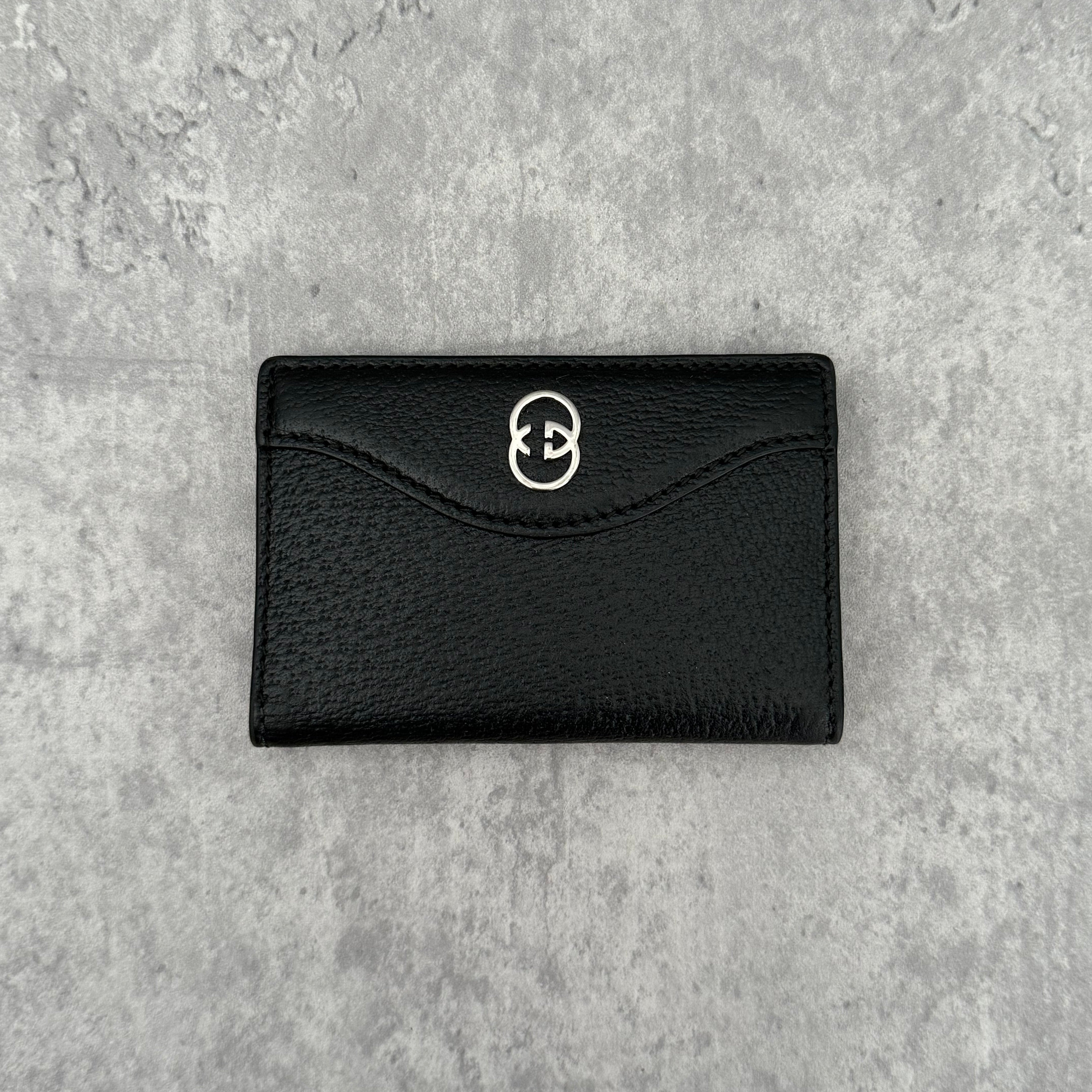 Gucci Interlocking G Black Leather Cardholder, featuring pebbled leather and silver-tone logo hardware in a slim bifold design