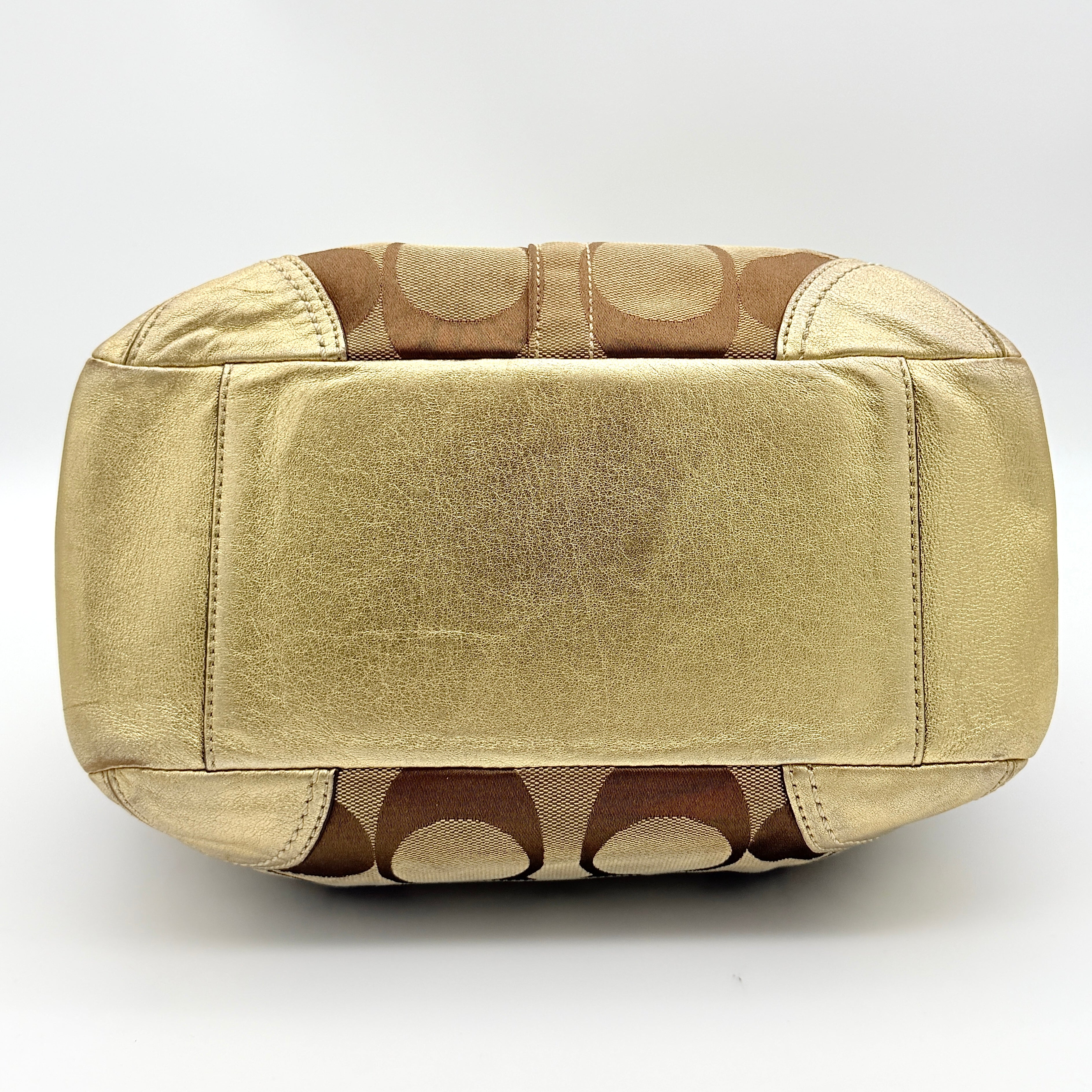Coach Ergo Hobo Shoulder Bag in beige jacquard canvas with gold leather trim, shown standing upright against a white background.