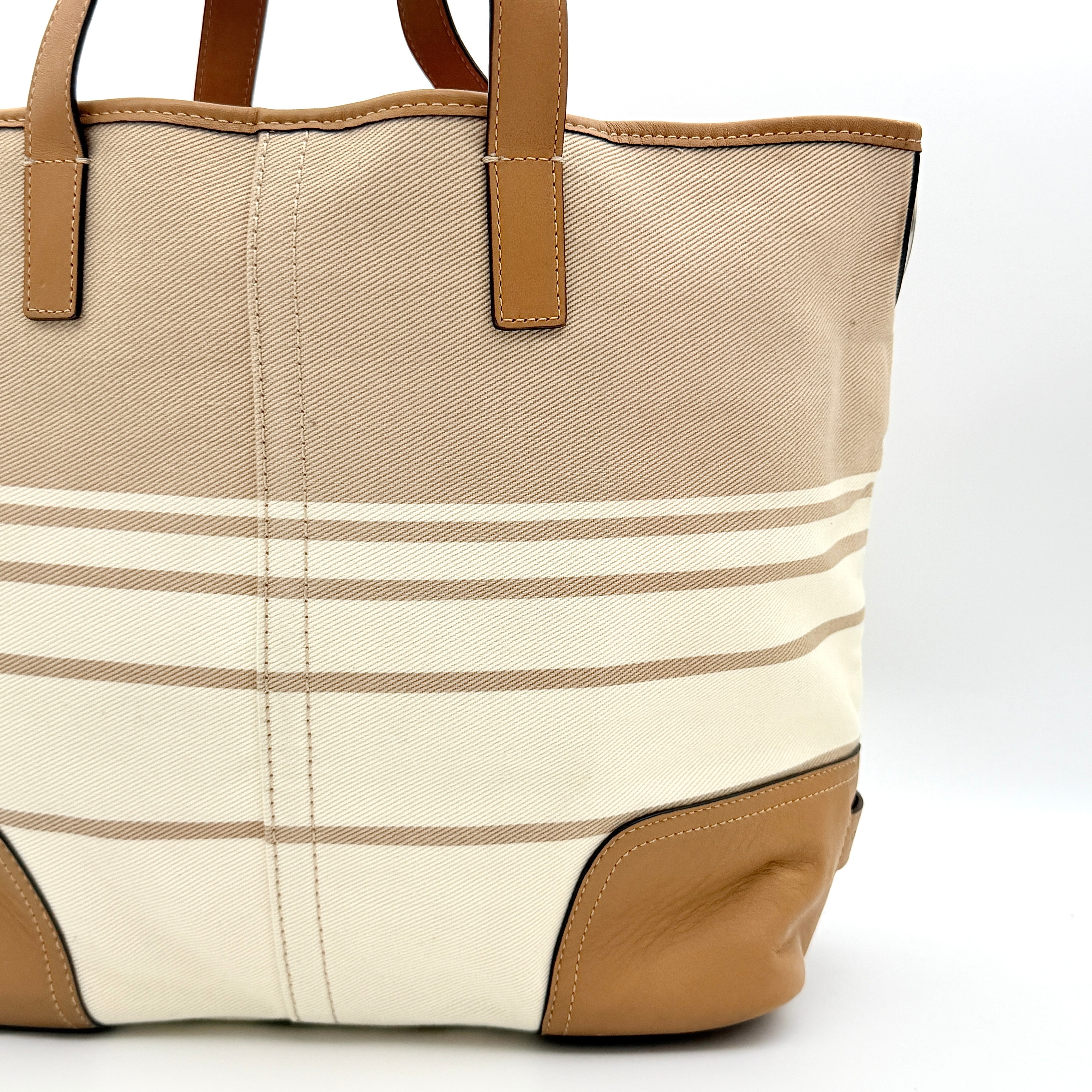 Coach Hadley Variegated Stripe Handbag in beige and tan canvas with leather trim, shown with top handles and detachable strap.