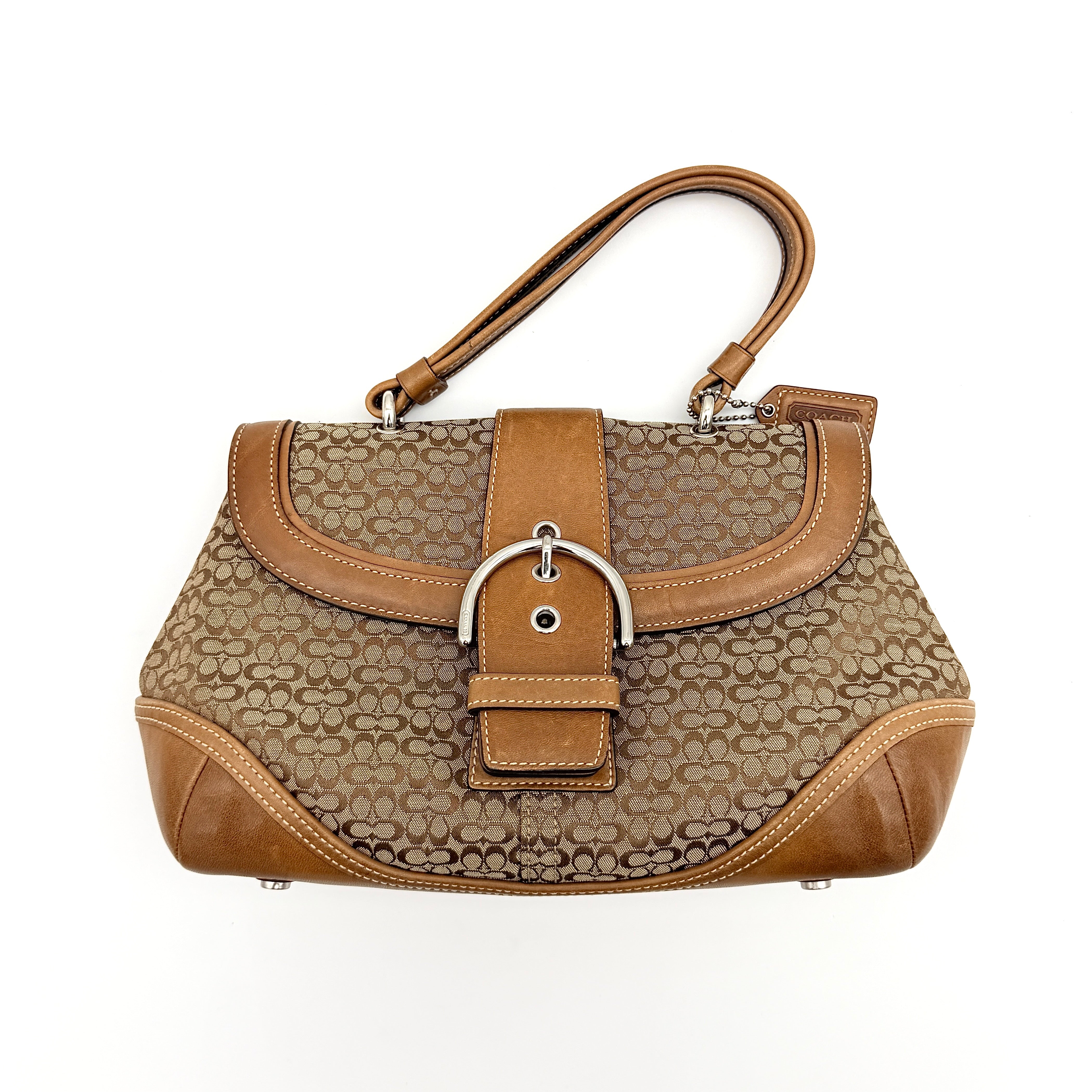 Coach Signature Soho Shoulder Bag in beige and tan monogram canvas with tan leather trim, shown on white background.