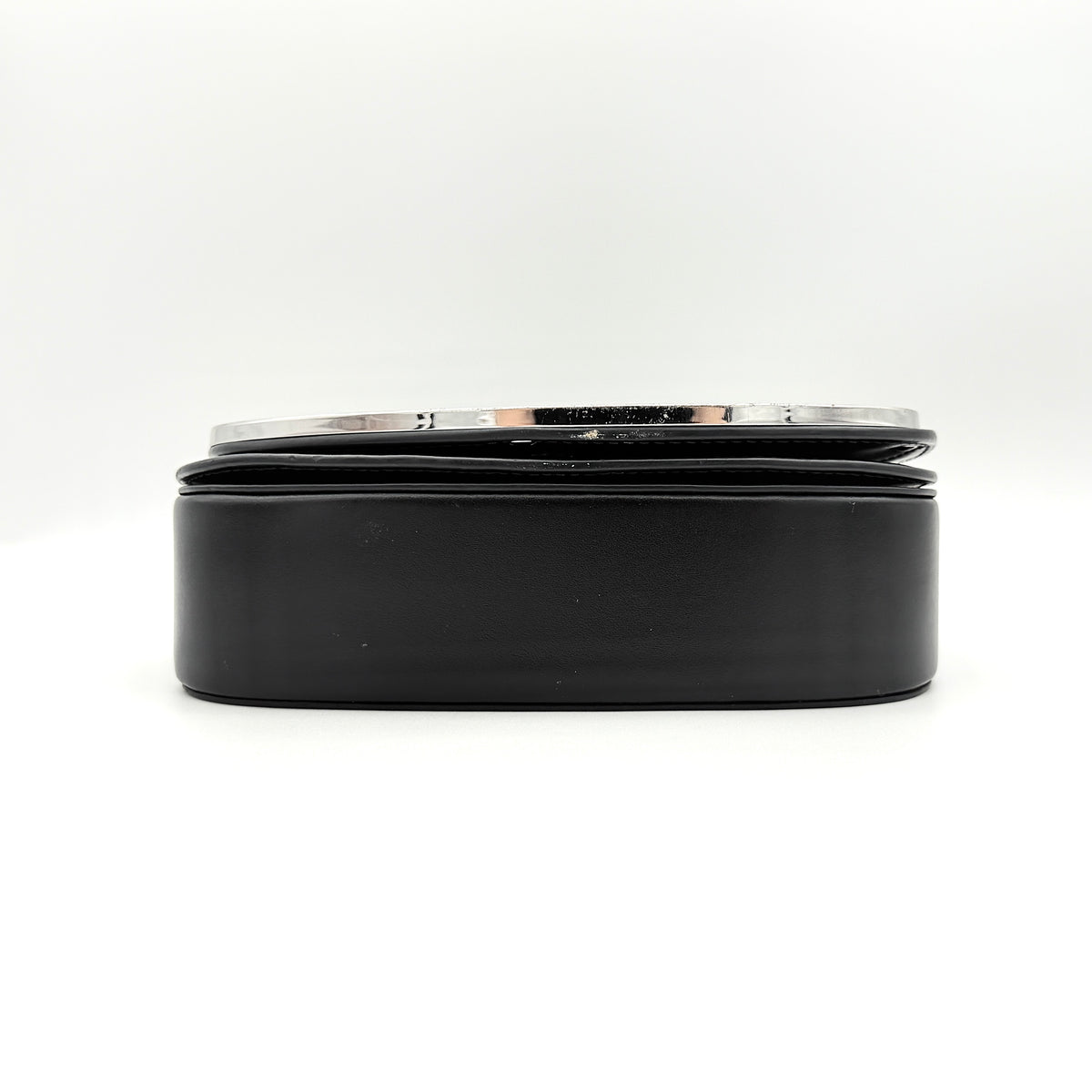 Diesel 1DR Shoulder Bag in black leather with a bold silver and black D logo plaque on the front flap.