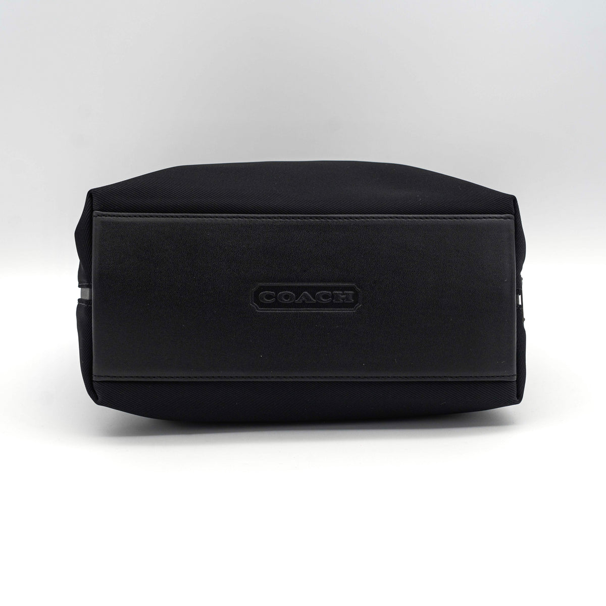 Coach Mercer tote bag in black nylon with leather handle and trim, presented against a white background.