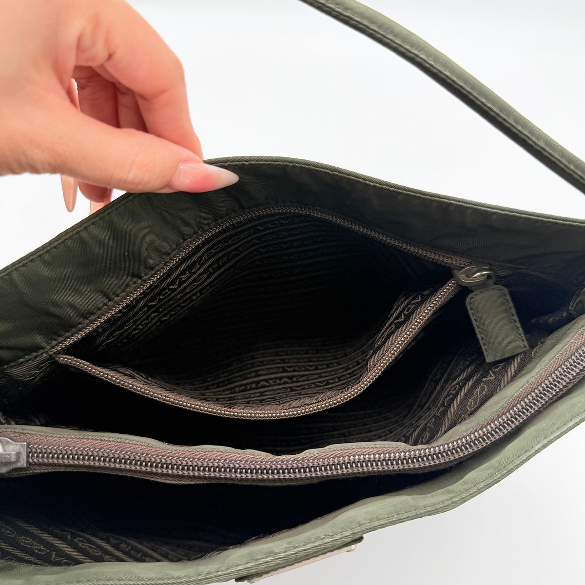 Prada Tessuto Nylon City Tote Bag in dark green nylon with double handles and signature triangle logo plaque on the front.