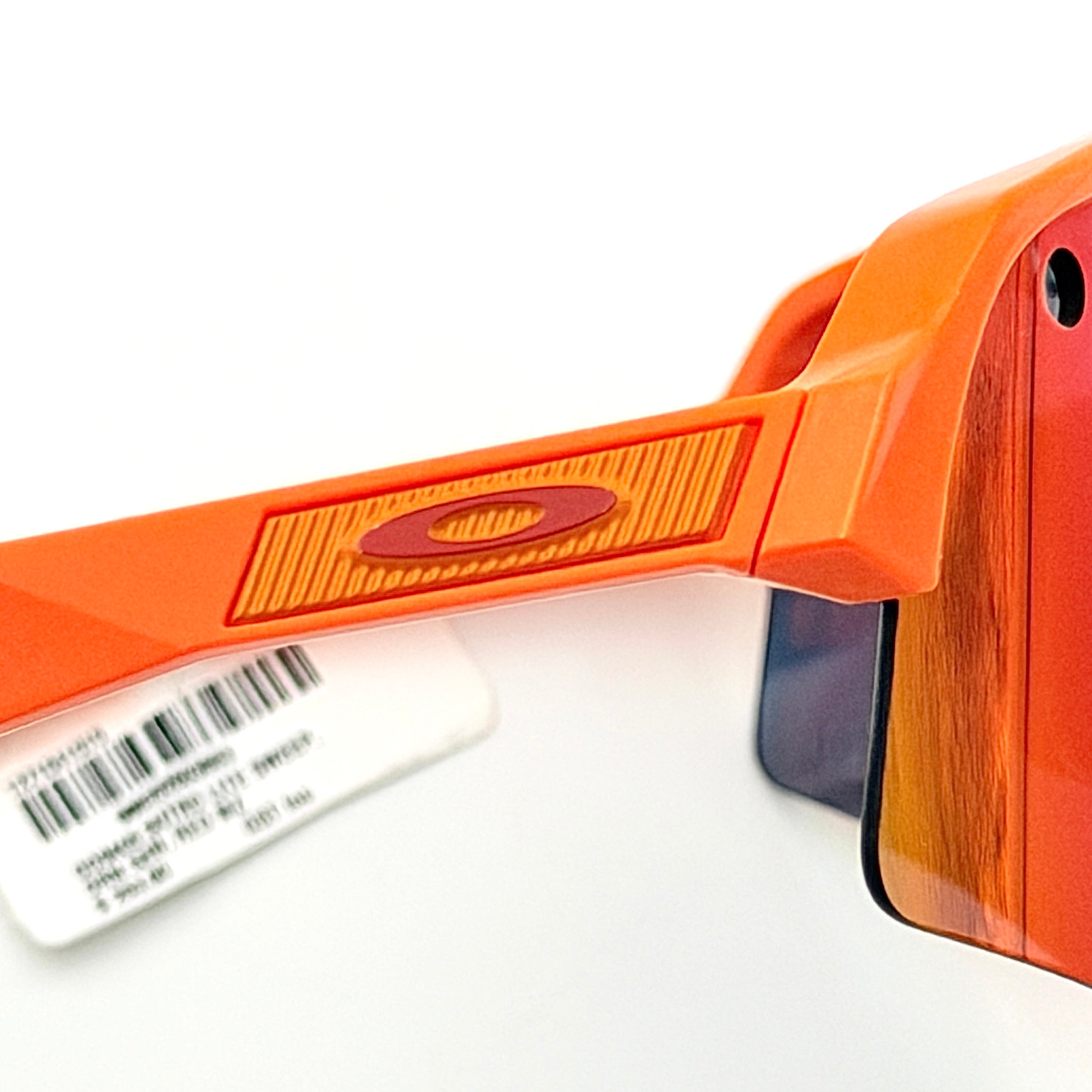 Oakley Sutro Lite Sweep MVDP Prizm Road sunglasses in orange sparkle with a shield lens and original pouch, photographed in bright studio lighting.