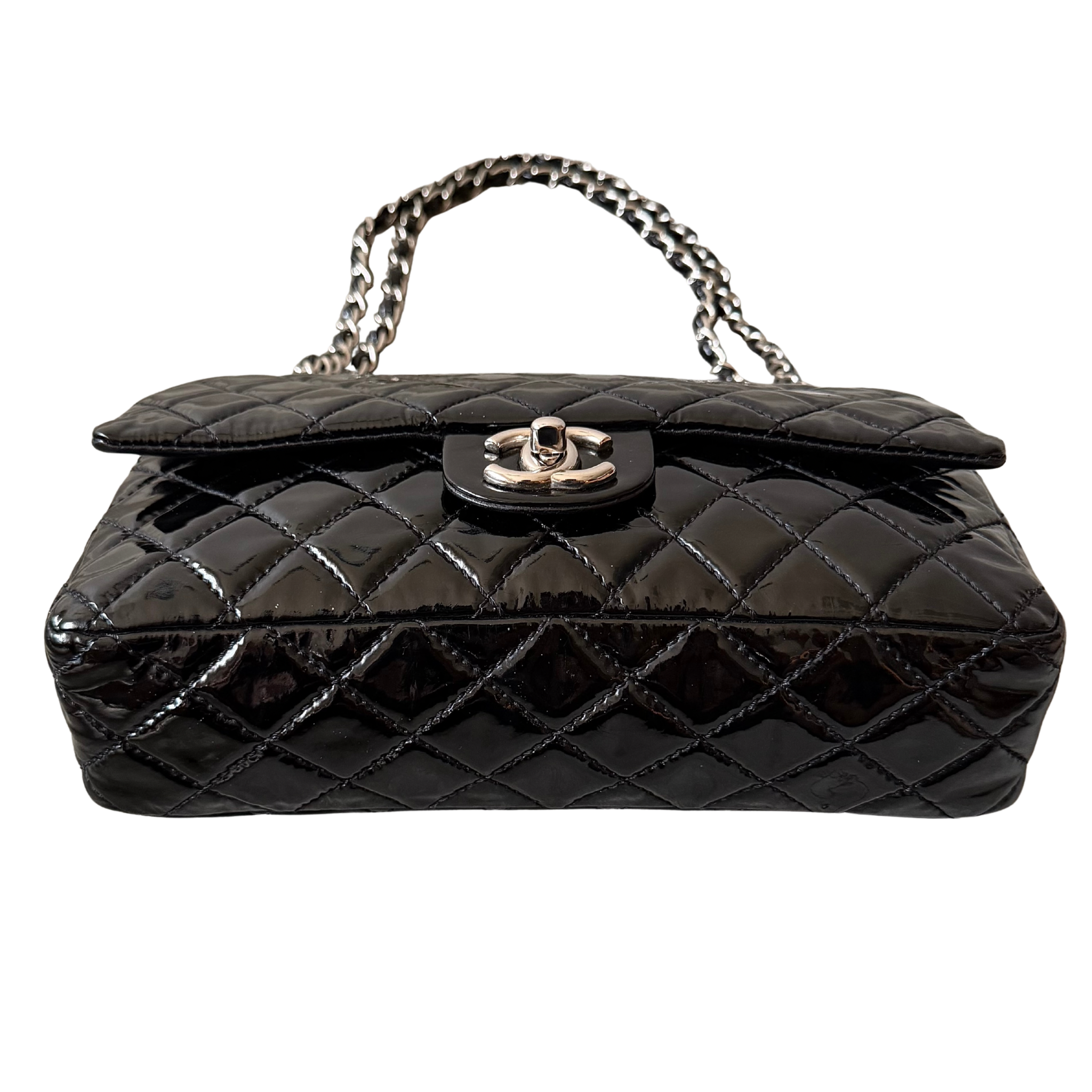 Chanel 25 Matelasse Double Flap bag in glossy black patent leather with silver-tone hardware and quilted finish.