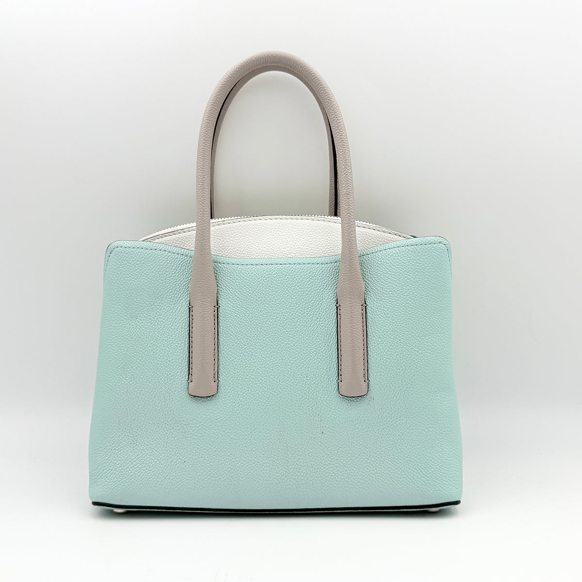 Kate Spade New York Margaux satchel in mint green pebbled leather with taupe handles, shown with its detachable strap and a clear pouch.