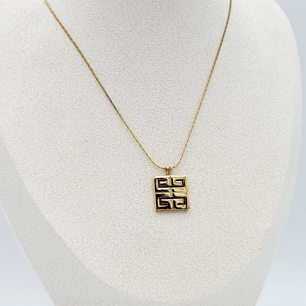 Givenchy 4G Logo Necklace in polished gold-tone metal with a geometric pendant on a fine chain.