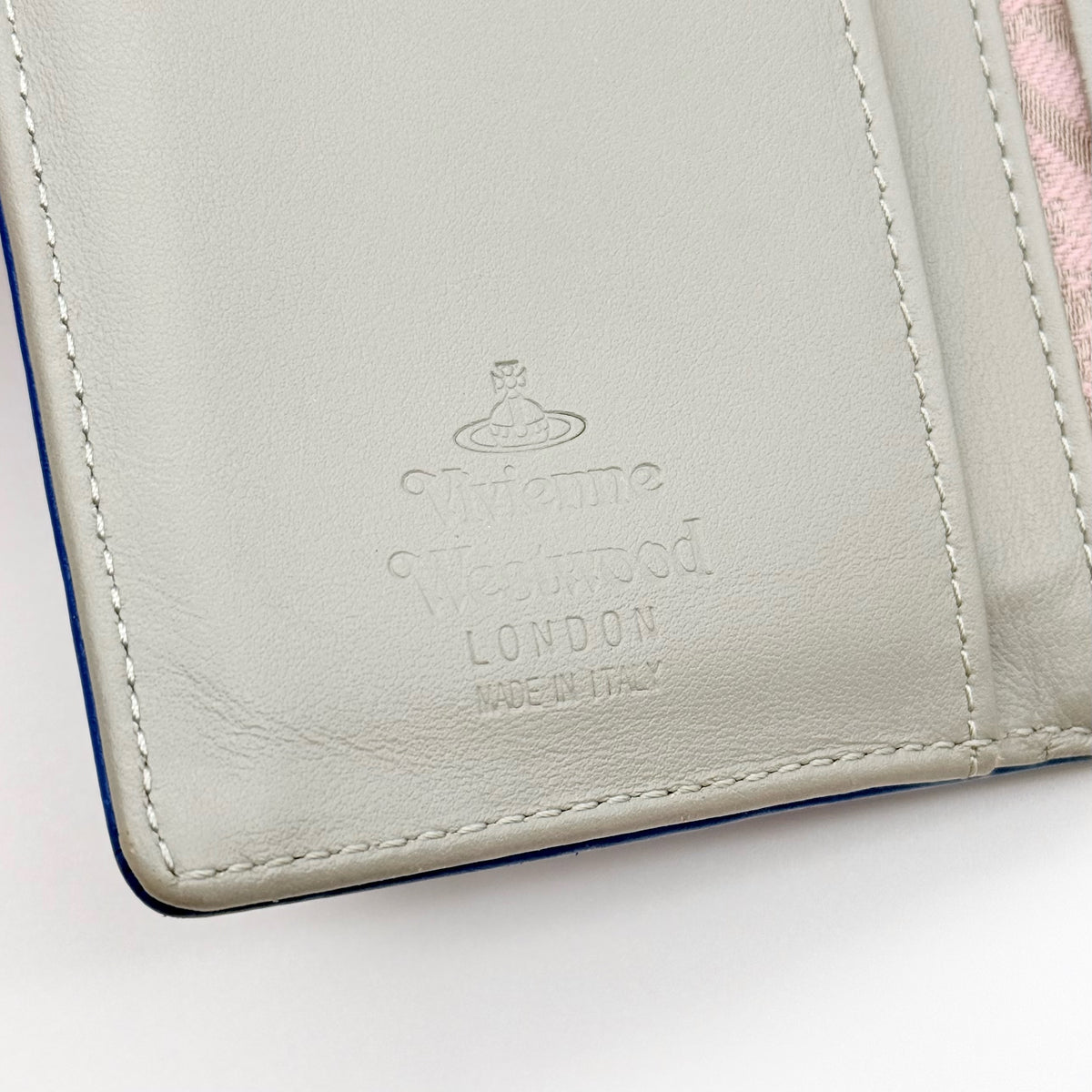 Vivienne Westwood blue leather trifold wallet with gold Orb emblem, shown with original box and documents.