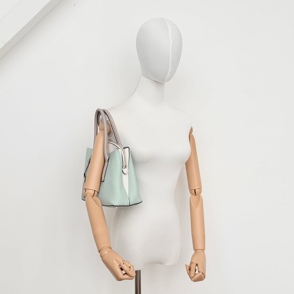 Kate Spade New York Margaux satchel in mint green pebbled leather with taupe handles, shown with its detachable strap and a clear pouch.