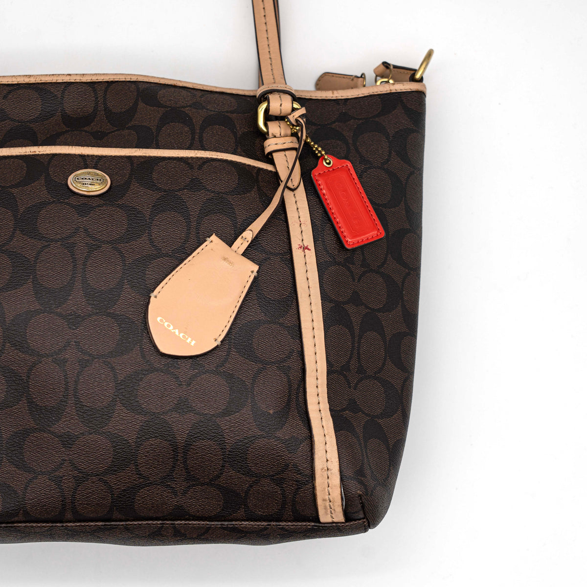 Coach Signature Peyton Pocket tote bag in brown canvas with tan leather trim, shown with both handles and detachable strap.