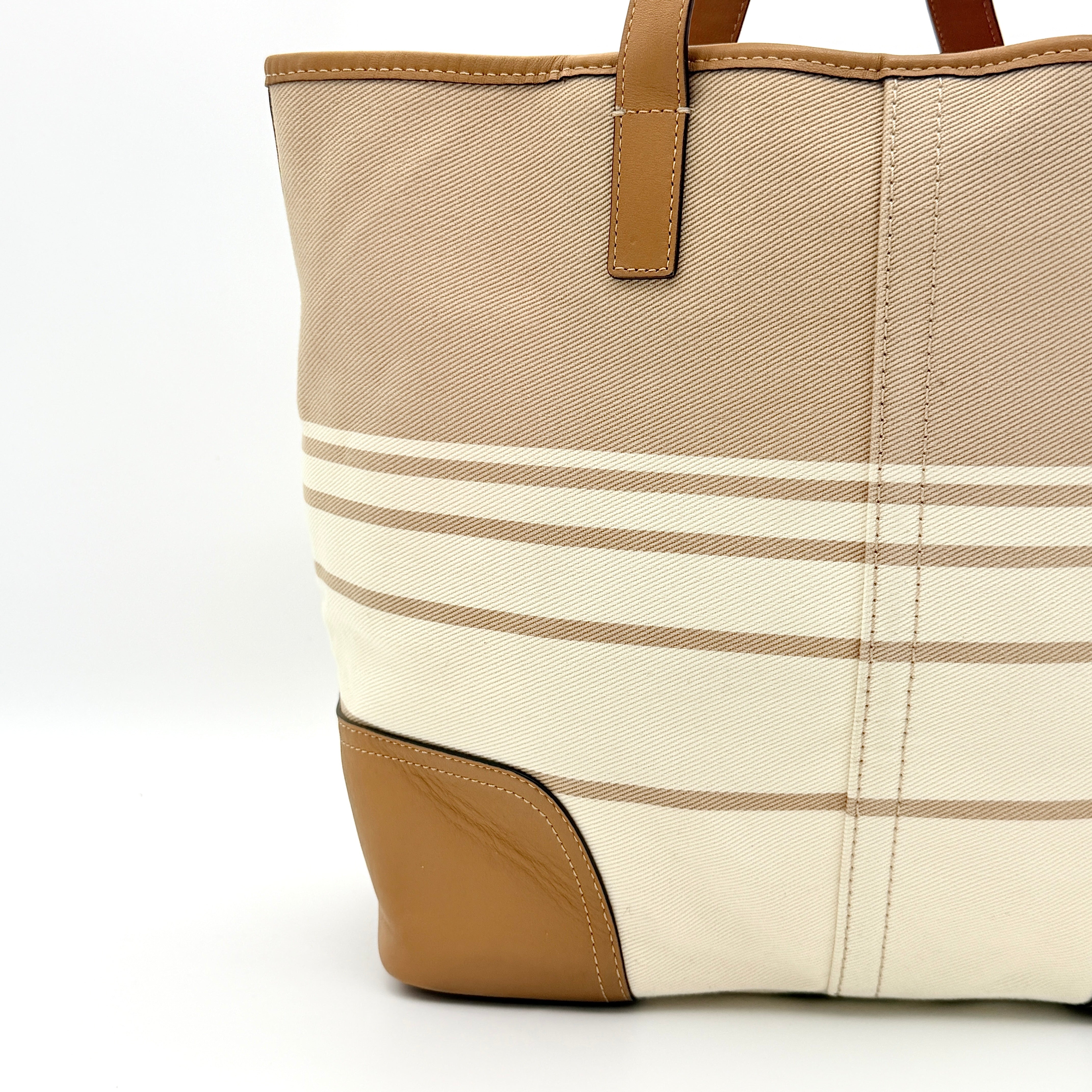 Coach Hadley Variegated Stripe Handbag in beige and tan canvas with leather trim, shown with top handles and detachable strap.