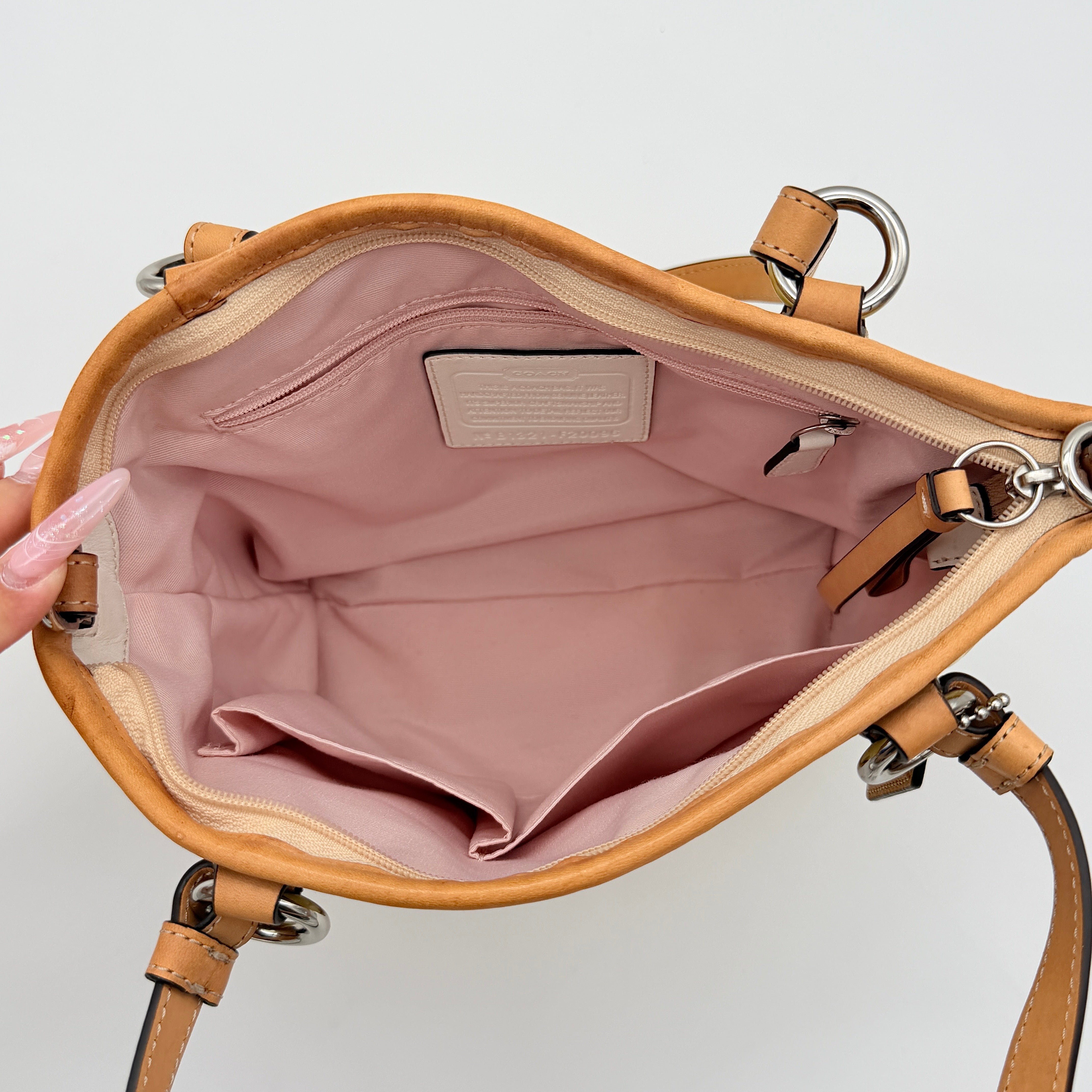Coach Peyton tote in glossy yellow patent leather with tan handles and detachable strap, shown with blush pink interior.