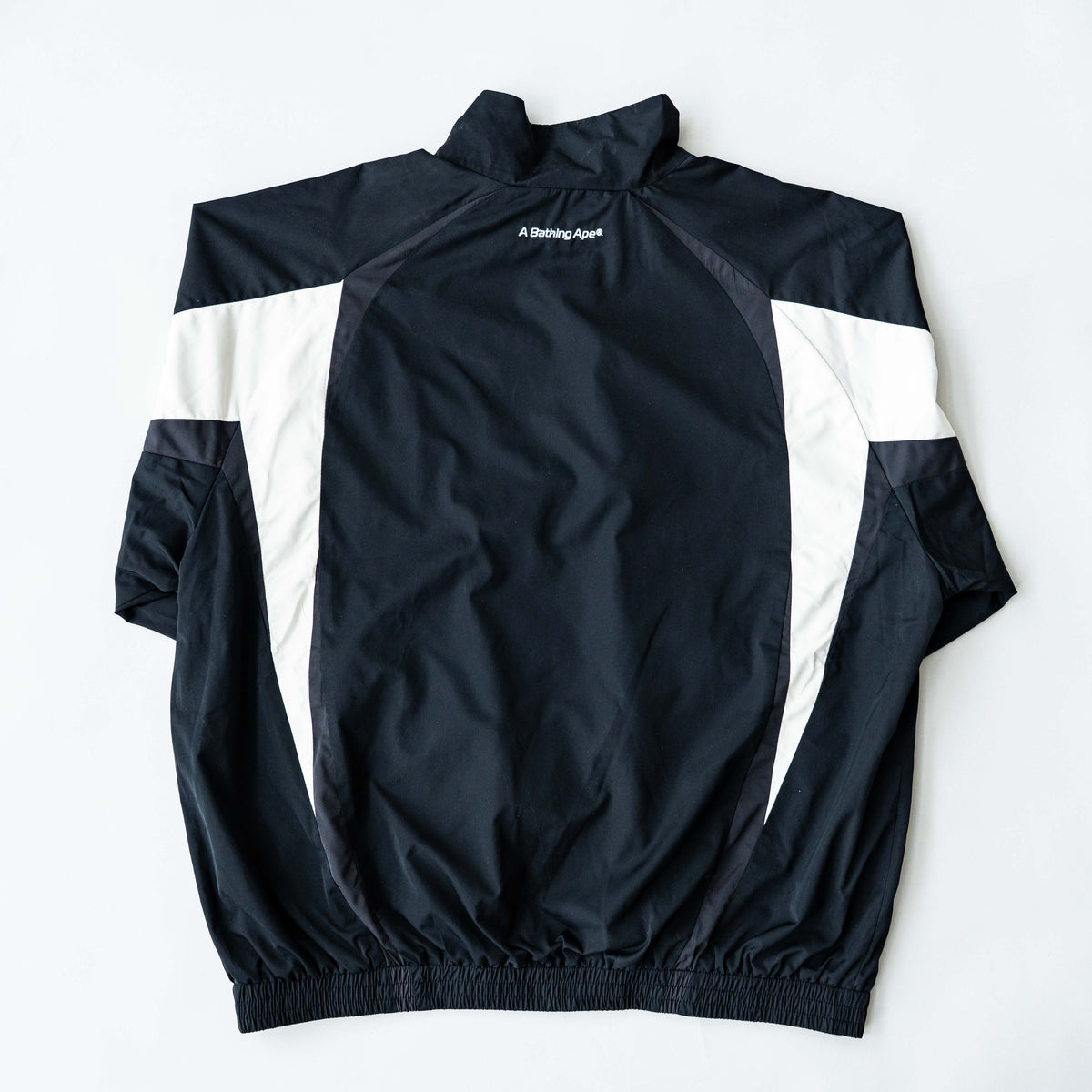 BAPE A Bathing Ape black and white logo track jacket with bold panel detailing, shown laid flat.
