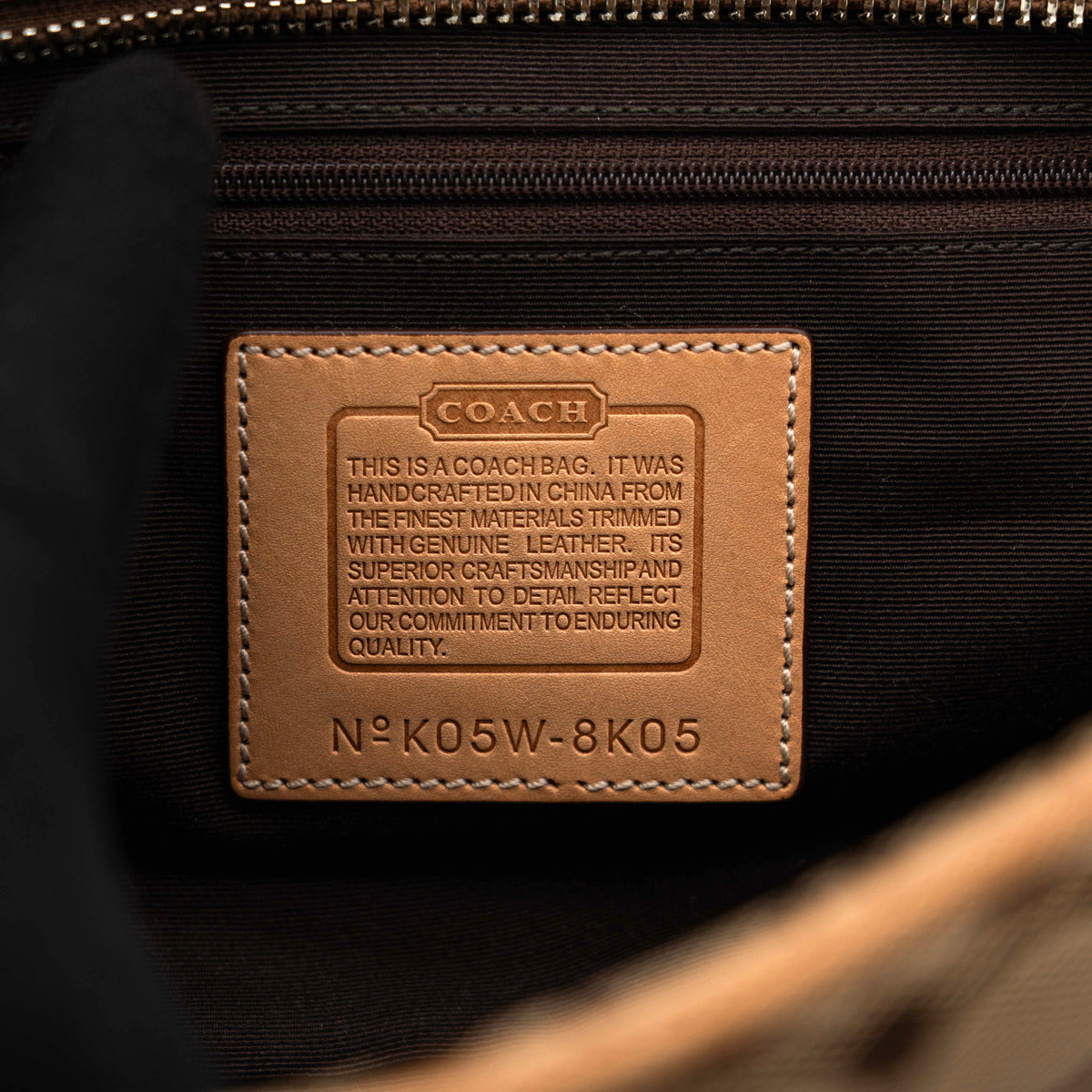 Coach Signature Hampton Satchel Boston Bag in beige and tan canvas with leather trim and silver hardware, styled on a clean background.