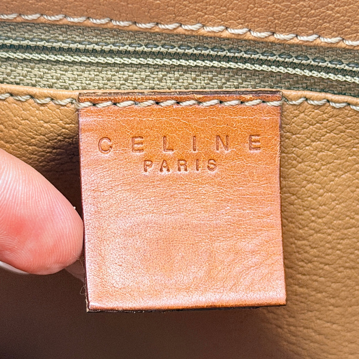 Celine Triomphe Macadam Boston Bag in brown coated canvas with tan leather handles and gold hardware on a white background.