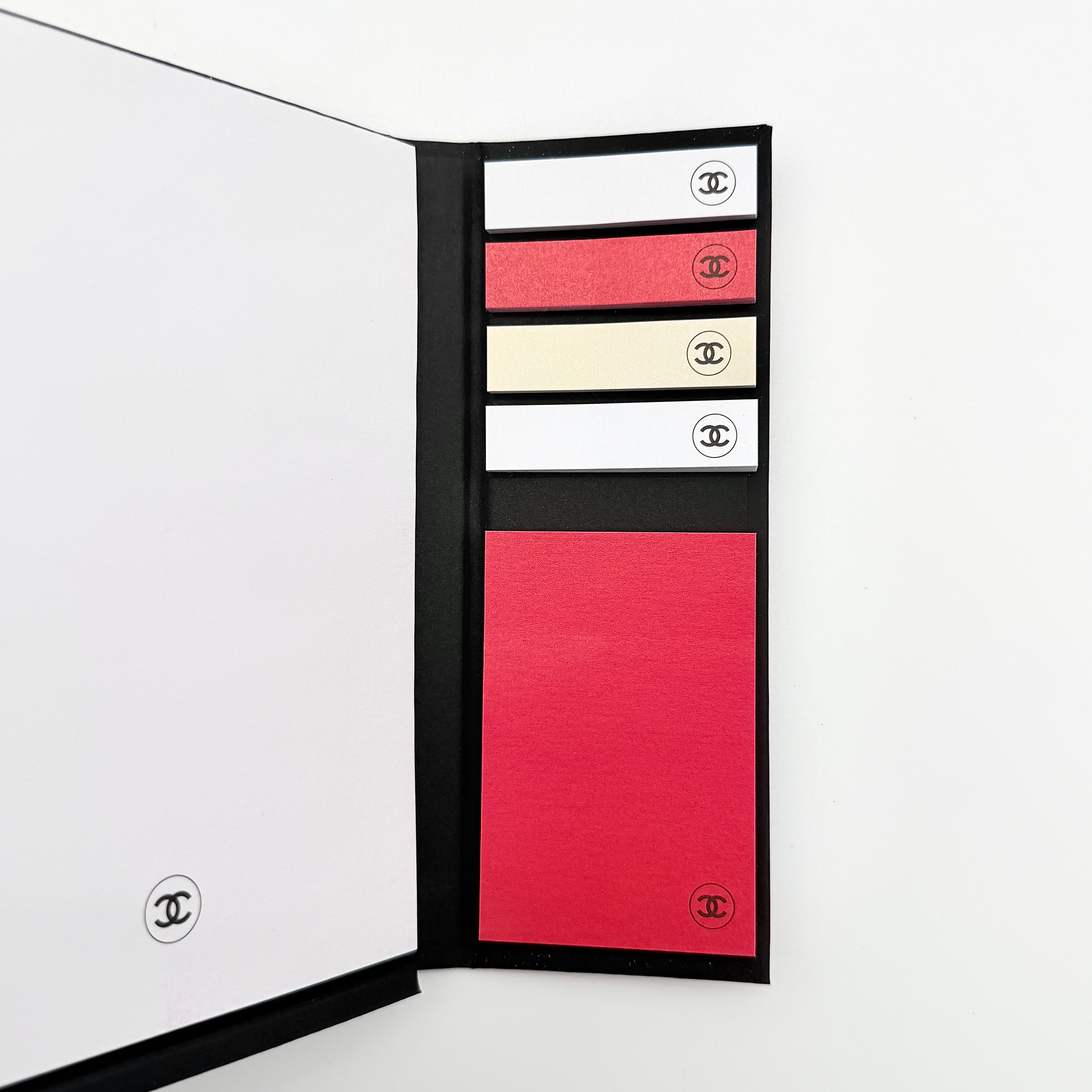 Chanel La Collection Novelty Book Stationary Set with black folder and branded box displayed on a white background