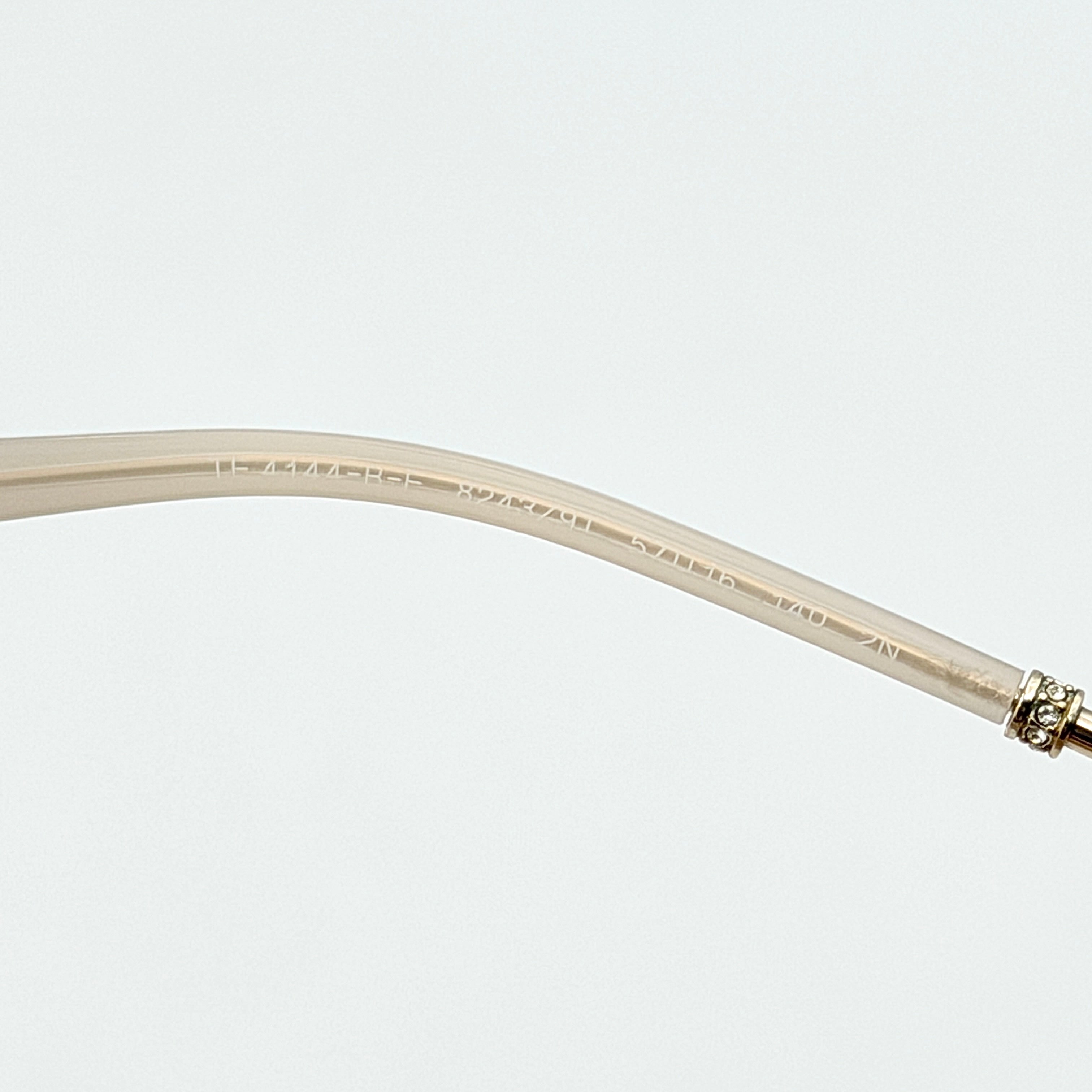 Tiffany & Co. TF4144 sunglasses in pink with gold-tone knot detail arms, shown with signature blue case.