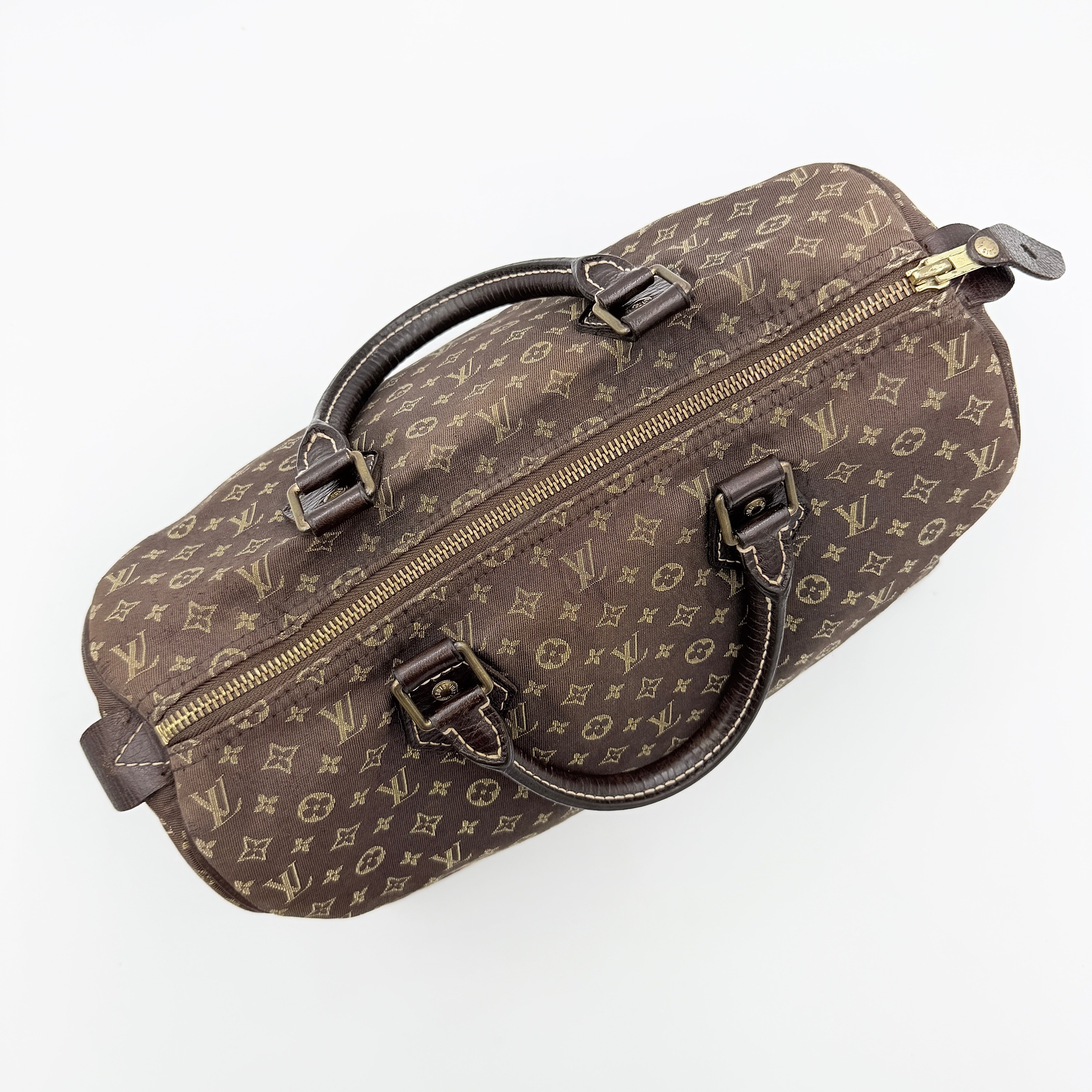 Louis Vuitton Monogram Mini Lin Speedy 30 in brown textile with top handles and monogram motif, shown against a white background.