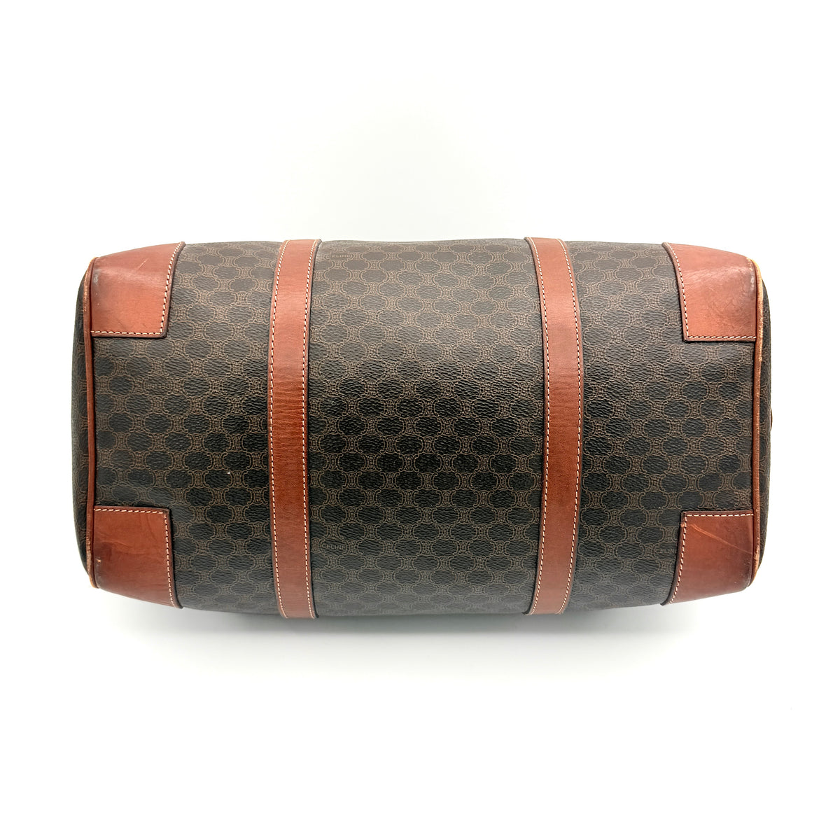 Celine Macadam Triomphe Boston Bag in brown coated canvas with tan leather and gold-tone hardware, shown against a white background.