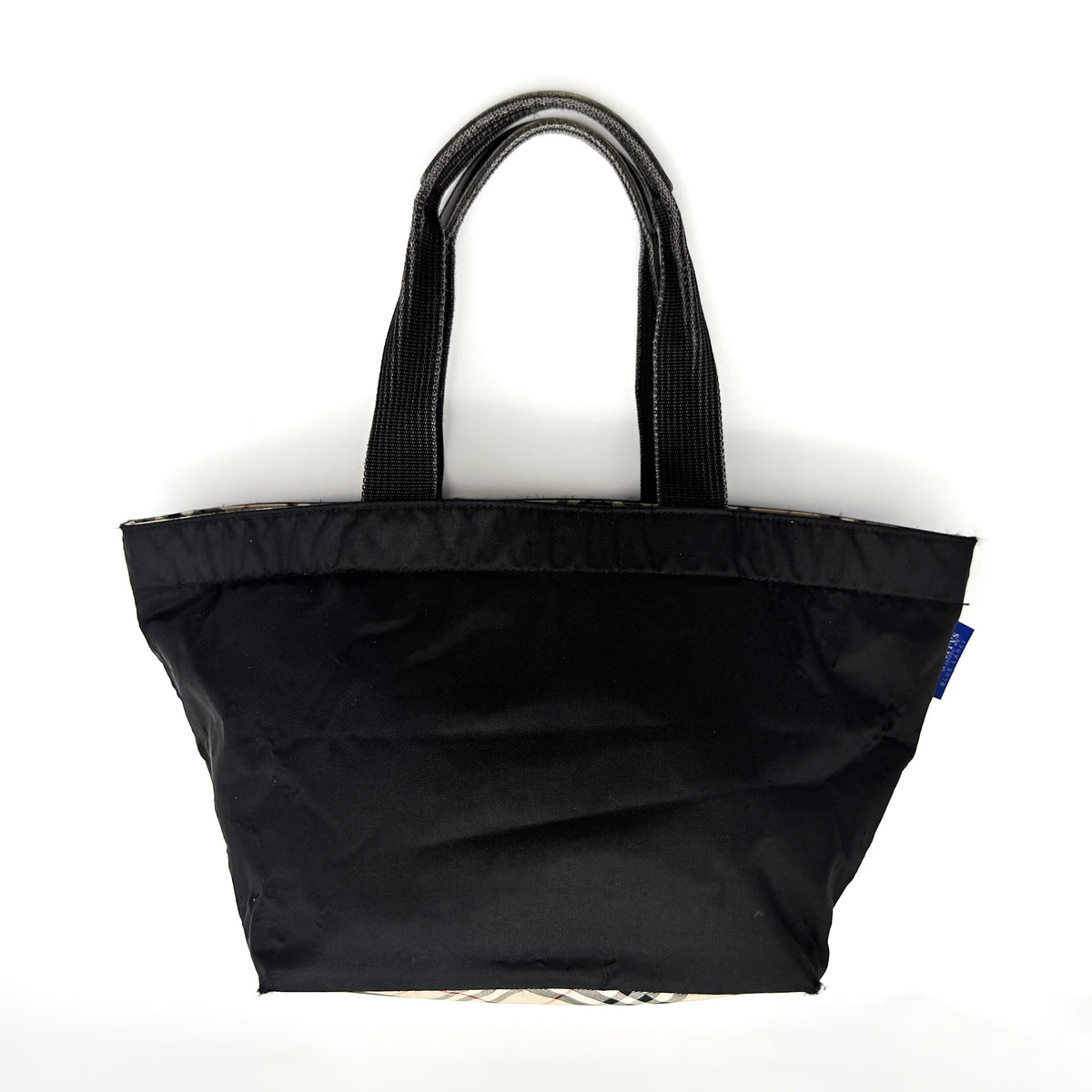 Burberry Blue Label Nova Check tote bag in black nylon with beige checked base and webbed handles, shown on white background.