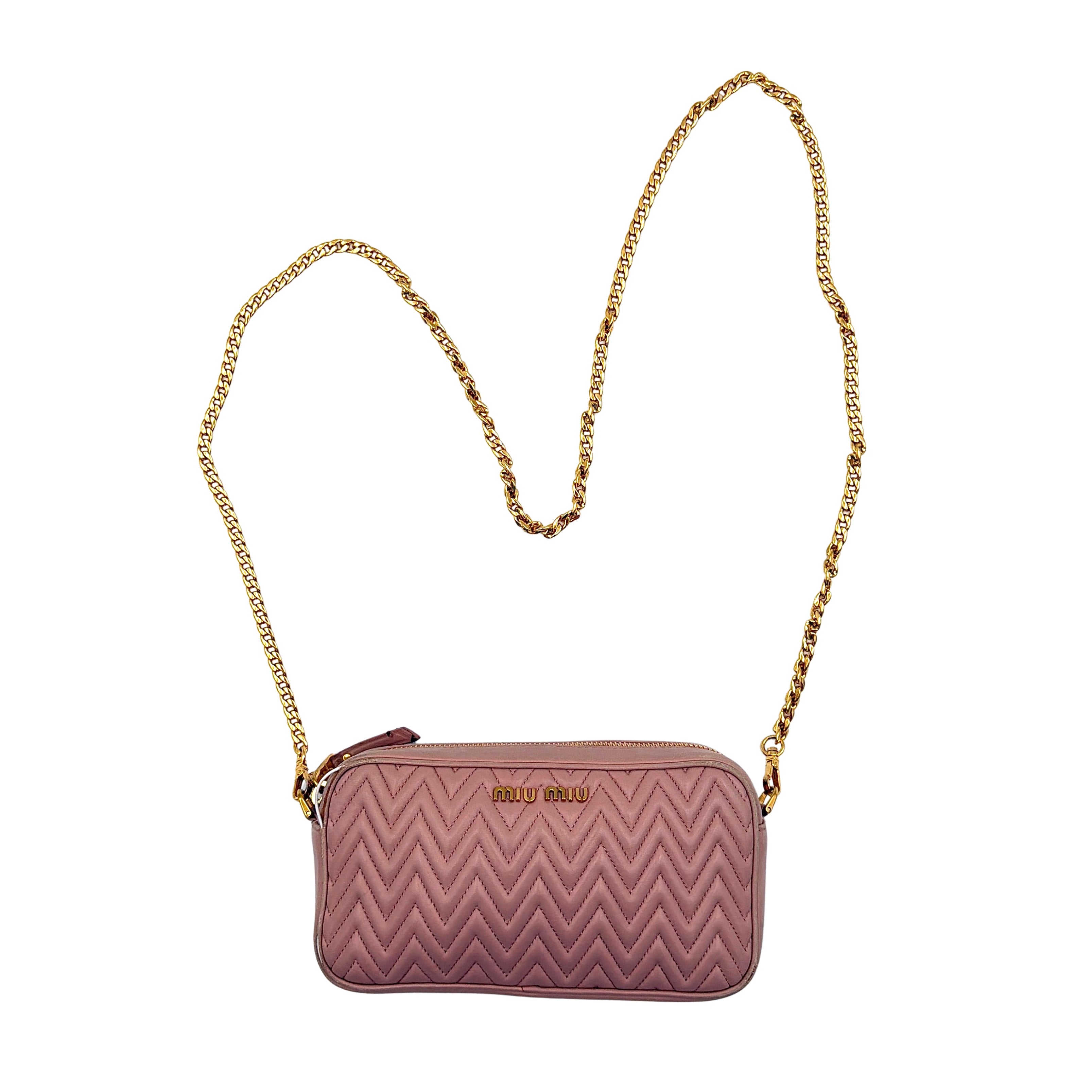 Miu Miu dusty pink quilted nappa mini crossbody bag with gold-tone chain strap and zip closure, showcased on a clean white background.