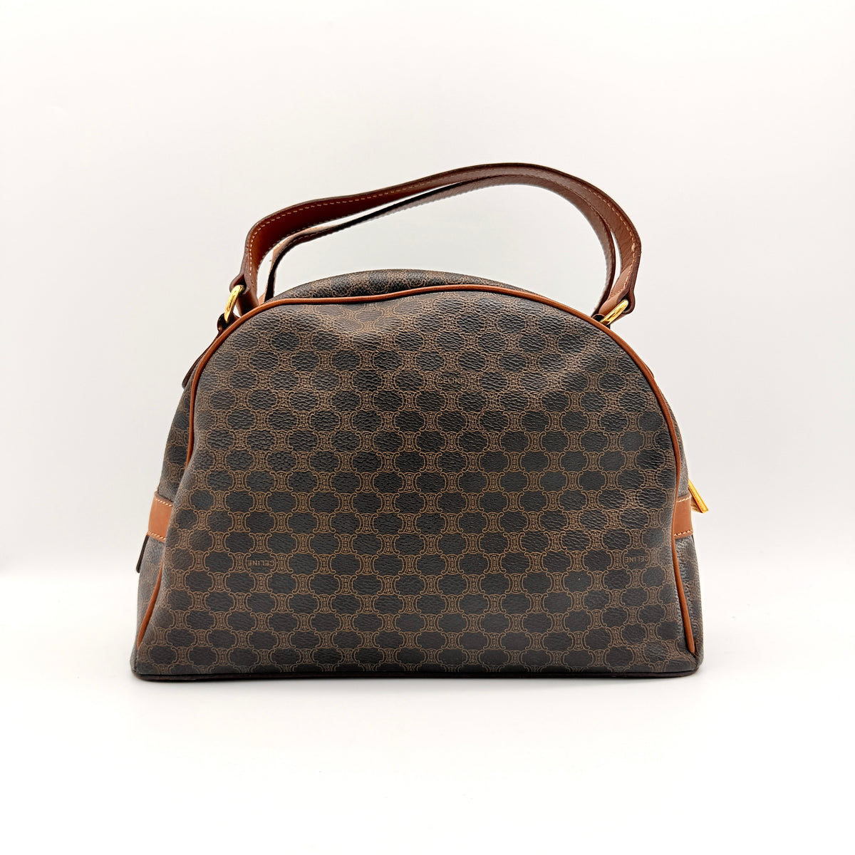 Front view of the Celine Triomphe Macadam Dome Handbag in brown, featuring the signature monogram canvas and tan leather details.