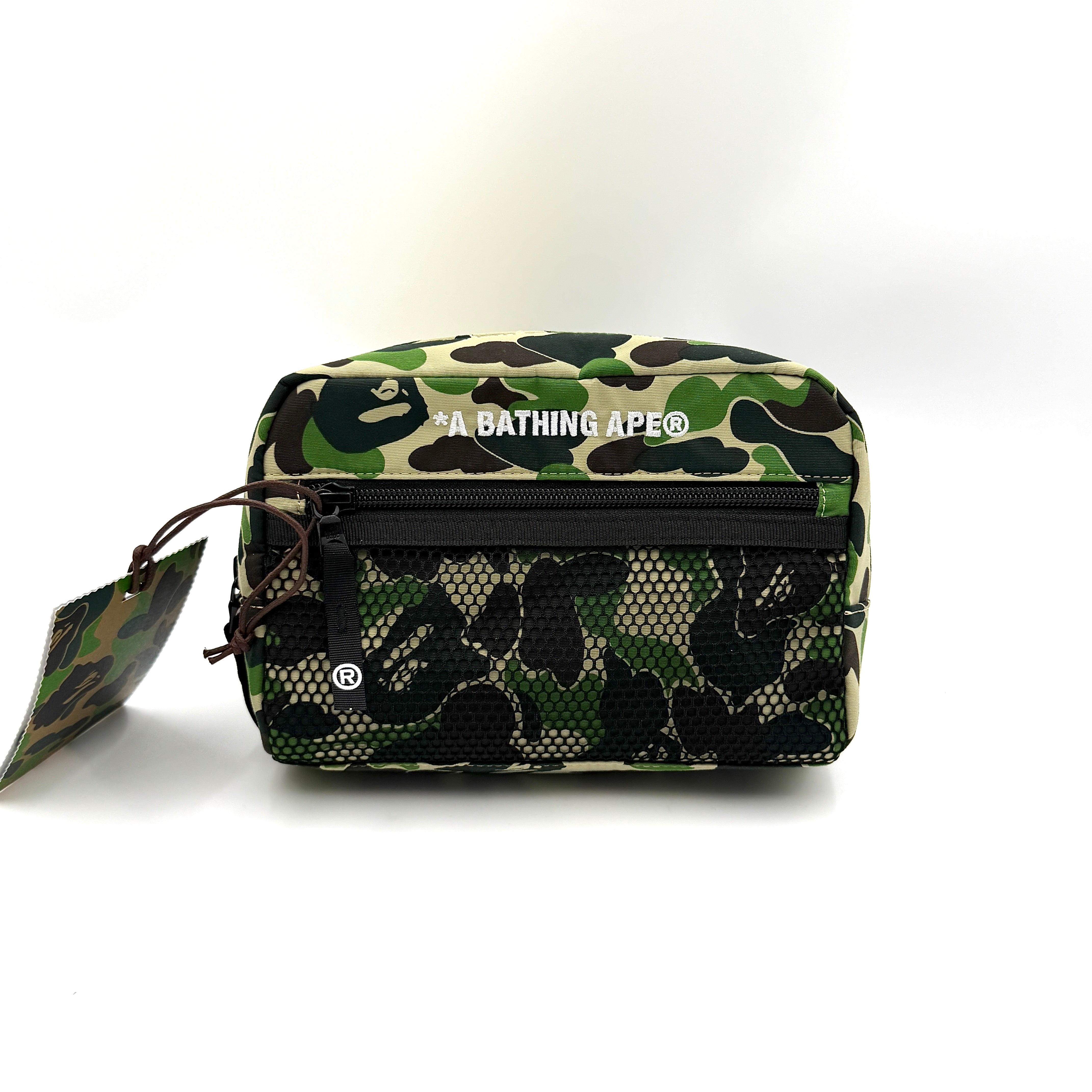 BAPE ABC Camo Pouch in green camouflage with mesh front pocket and embroidered A Bathing Ape logo.