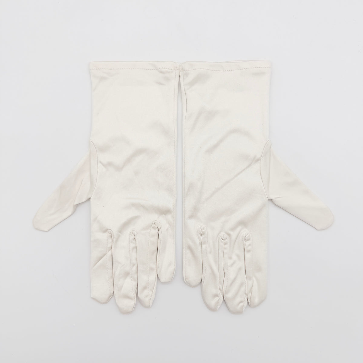 Pair of Cartier ivory gloves with signature script logo embroidery displayed on a flat white background.