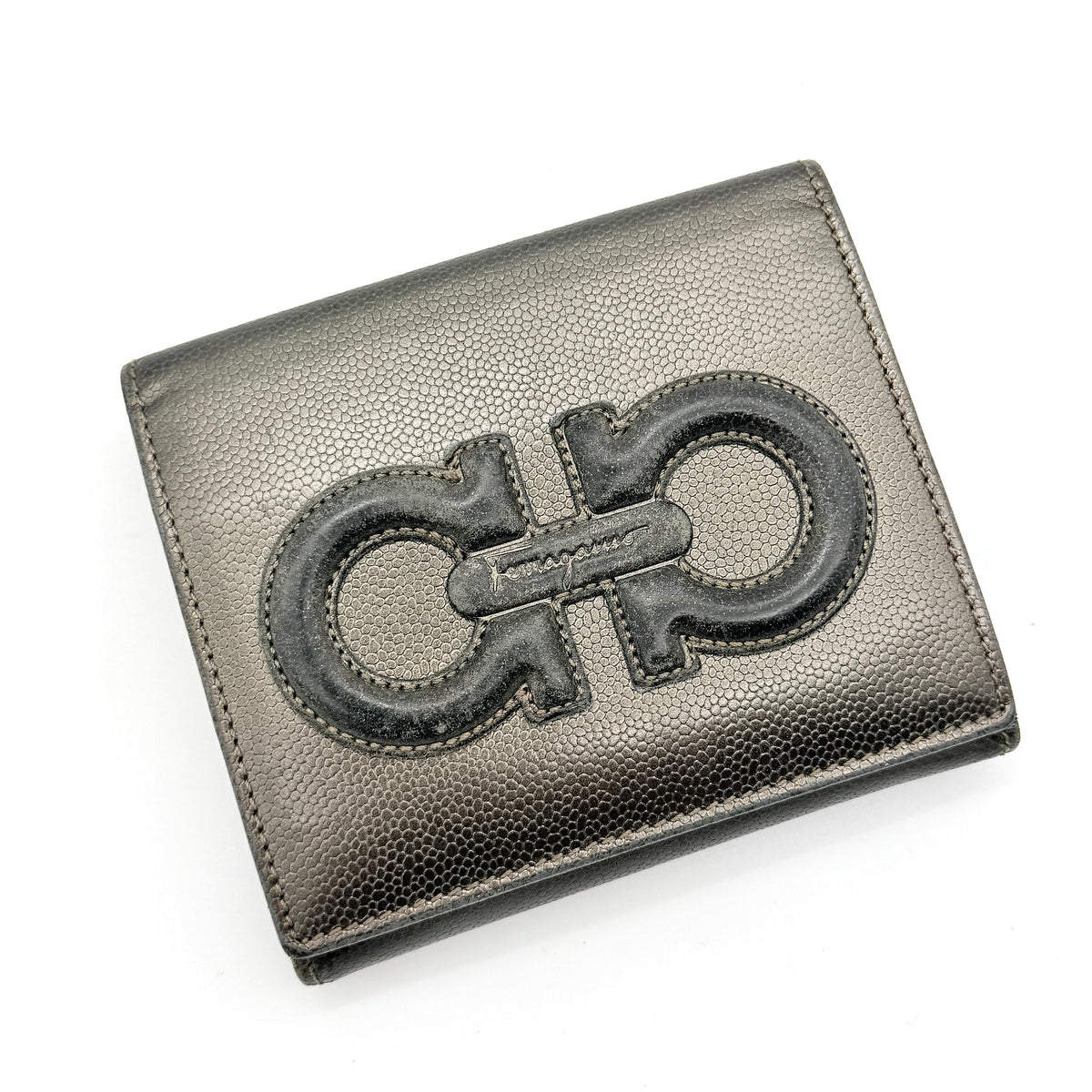 Salvatore Ferragamo Gancini Embossed Bifold Wallet in metallic grey textured leather, front view.