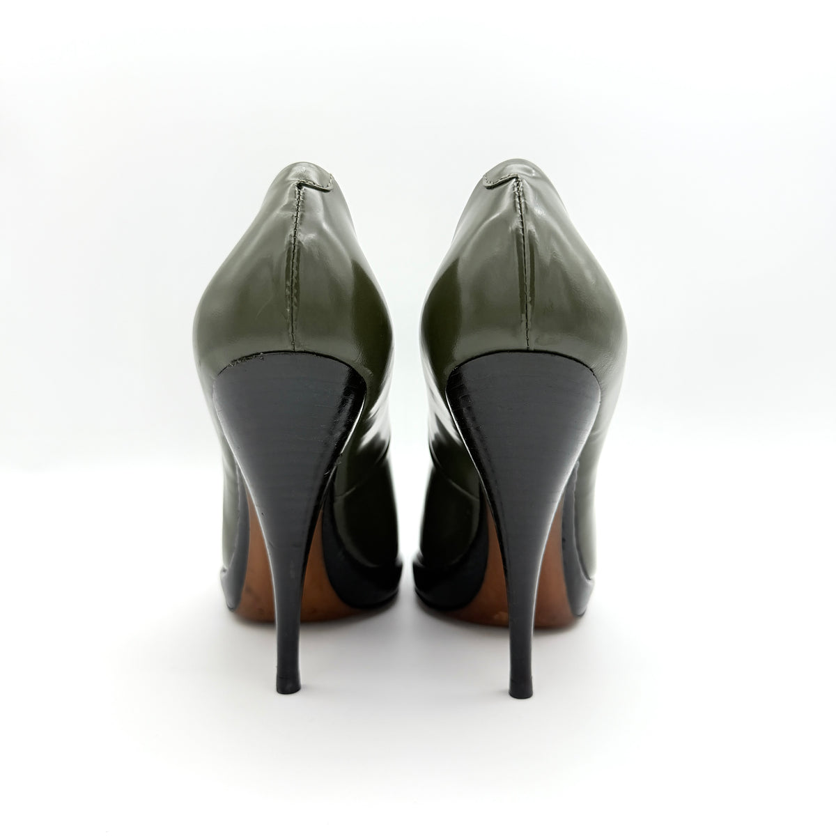 Celine olive green leather heels with pointed toe and black stiletto heel, displayed against a white background