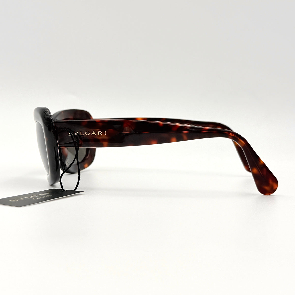 Bvlgari 808 sunglasses in tortoiseshell brown acetate displayed with original case and cloth.