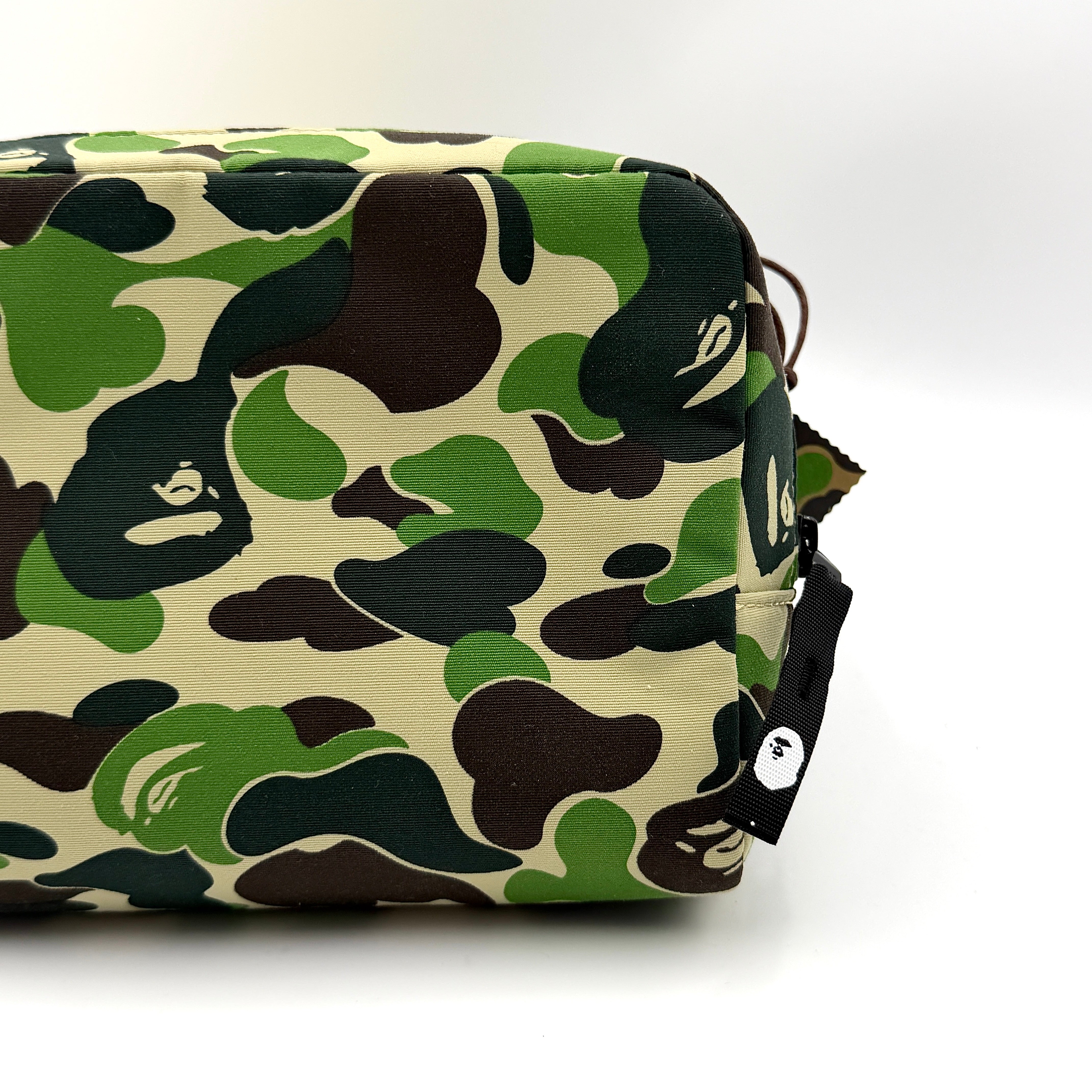 BAPE ABC Camo Pouch in green camouflage with mesh front pocket and embroidered A Bathing Ape logo.
