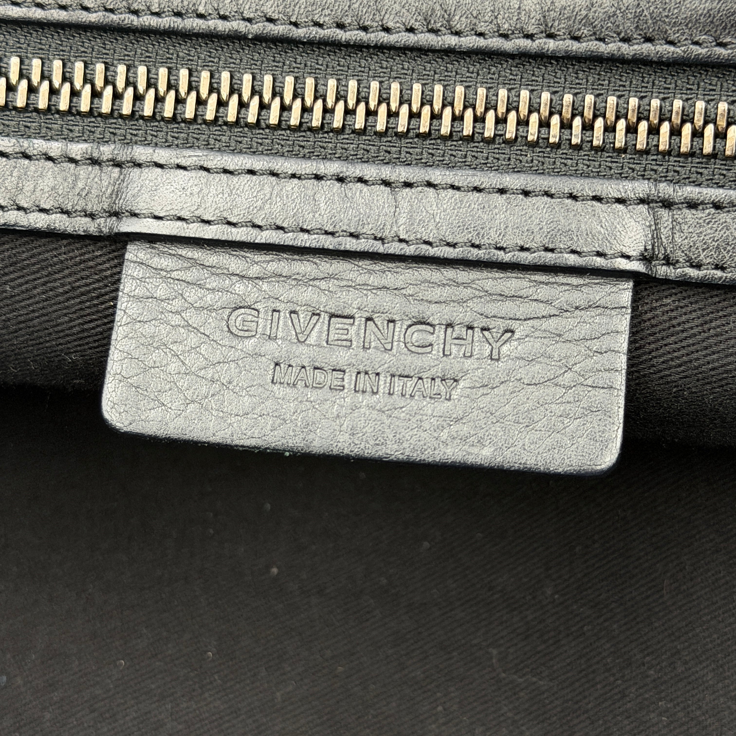 Givenchy 2Way Nightingale Handbag in black leather with detachable strap and striking front motif.
