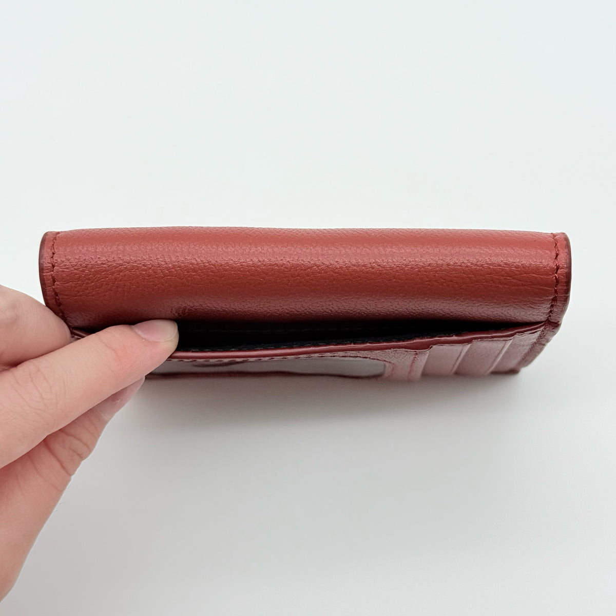 See by Chloé red leather card case with gold-tone ring detail, shown with authenticity card.