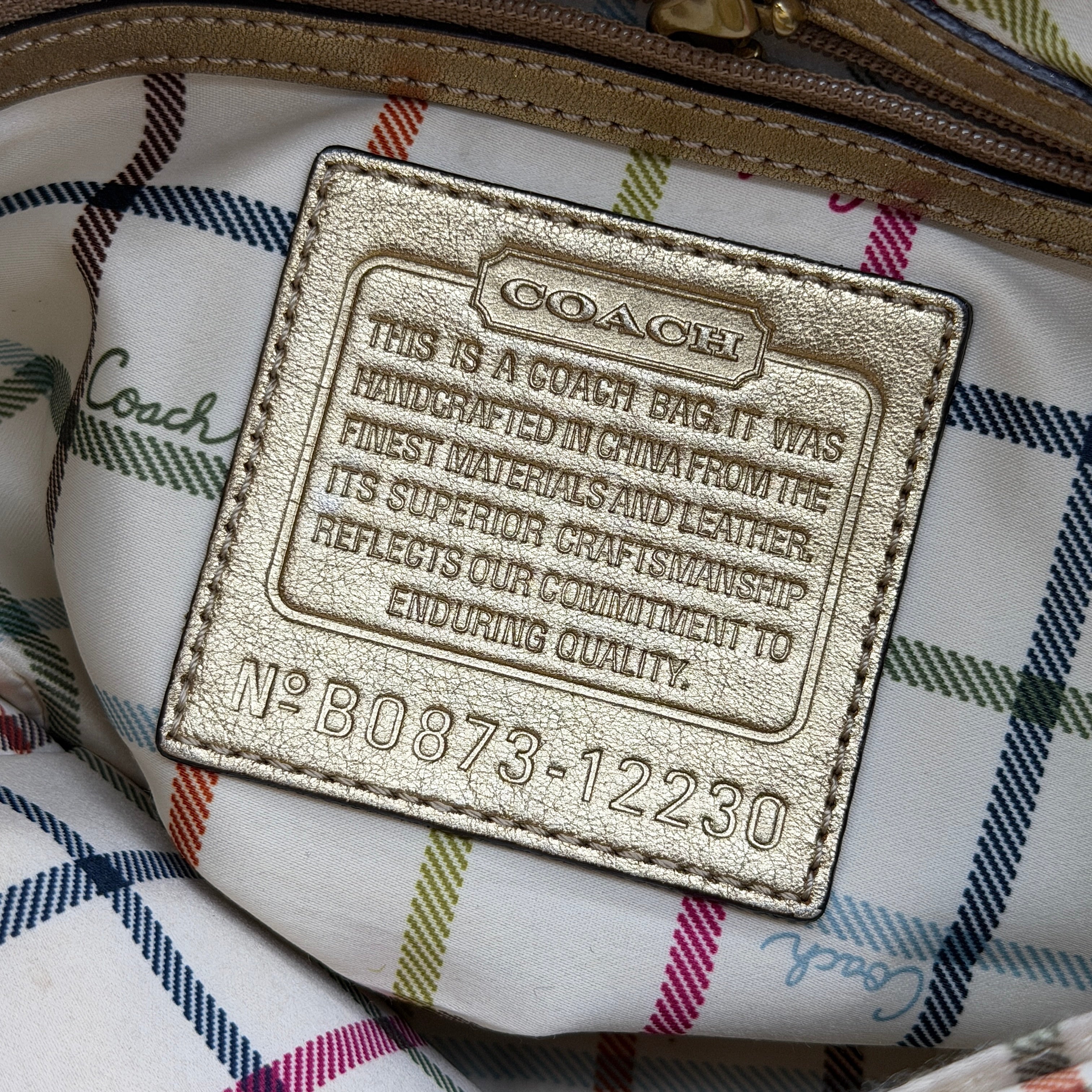 Coach Ergo Hobo Shoulder Bag in beige jacquard canvas with gold leather trim, shown standing upright against a white background.