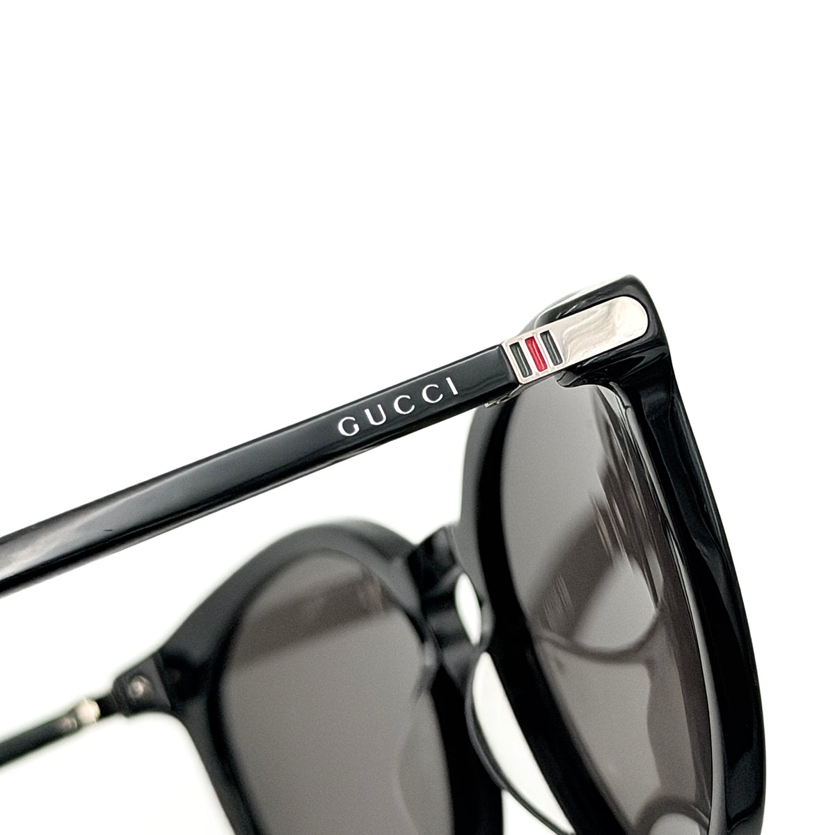 Gucci GG0064SK 001 black round sunglasses with smoky lenses, shown with original burgundy velvet case and pouch.