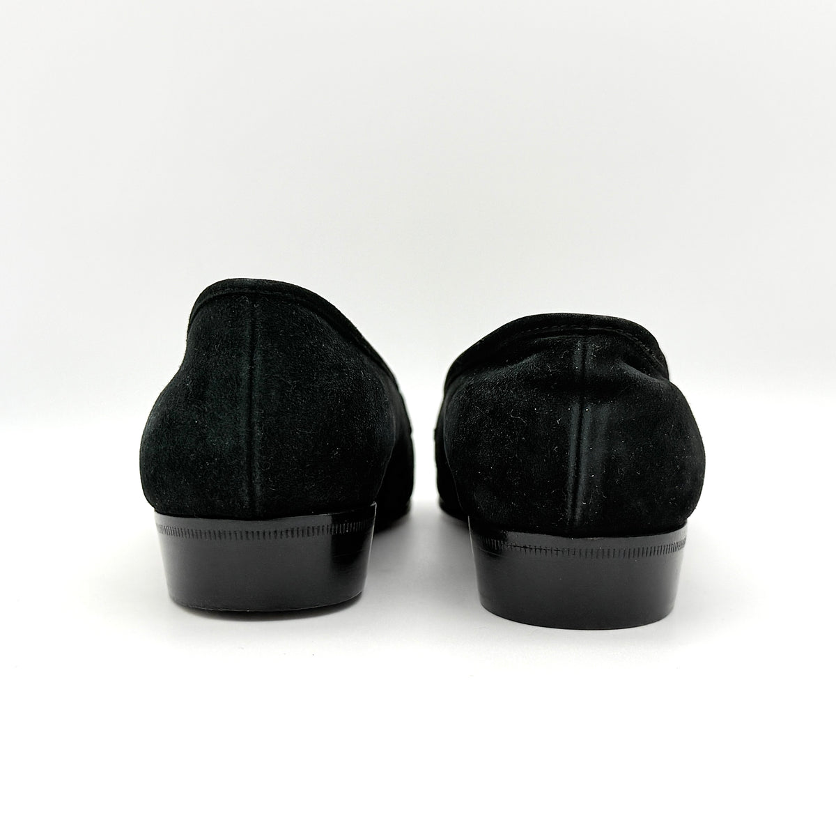 Salvatore Ferragamo black suede loafers with gold Gancini horsebit detail, displayed side by side on a white background.