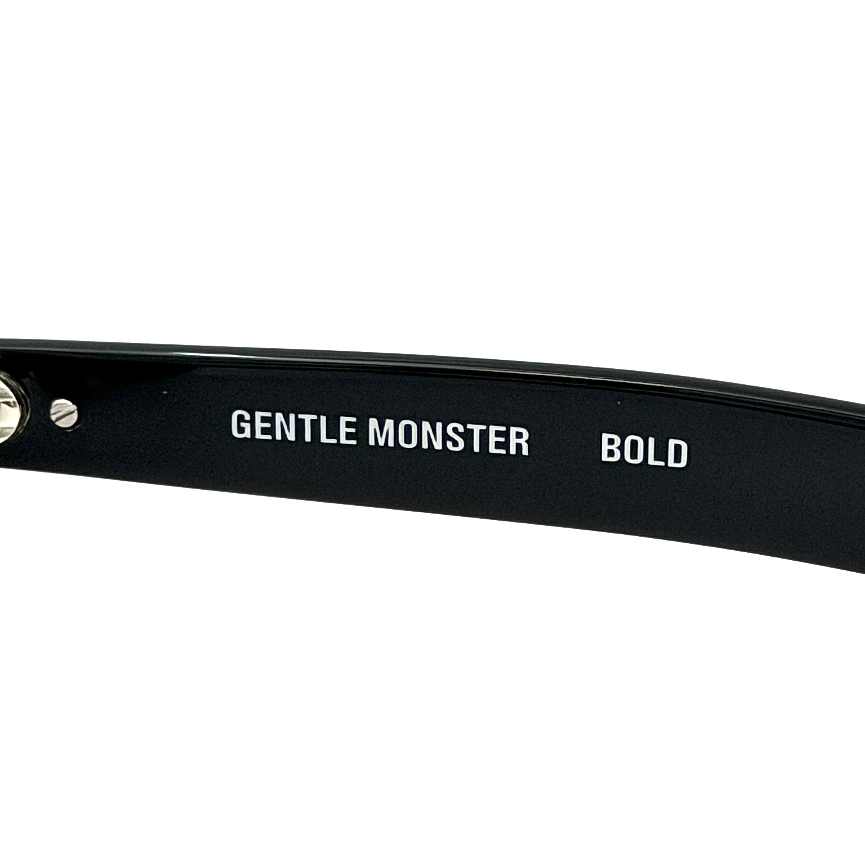 Gentle Monster Bandoneon.S sunglasses in black acetate with dark oval lenses and silver star accents shown from the side.