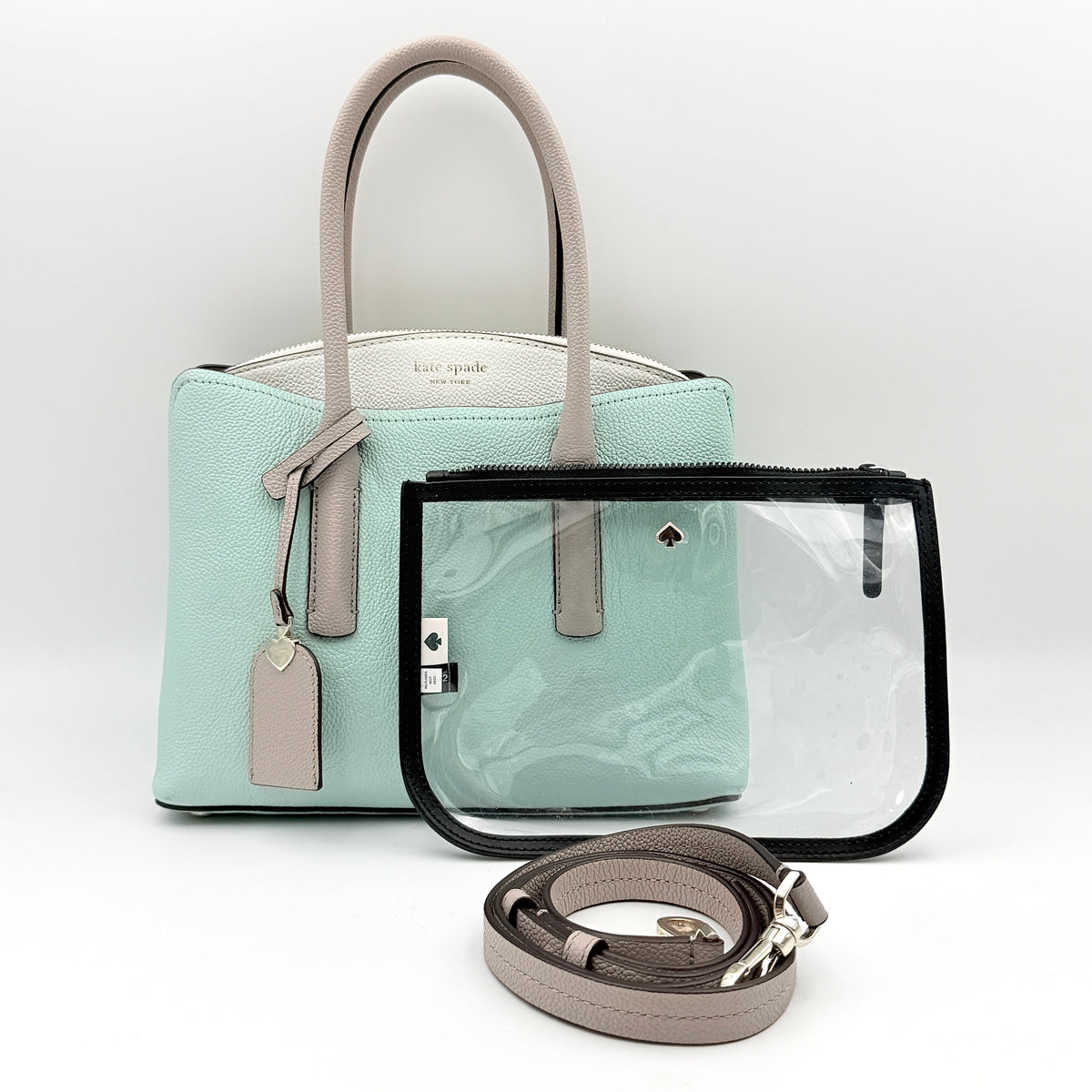 Kate Spade New York Margaux satchel in mint green pebbled leather with taupe handles, shown with its detachable strap and a clear pouch.