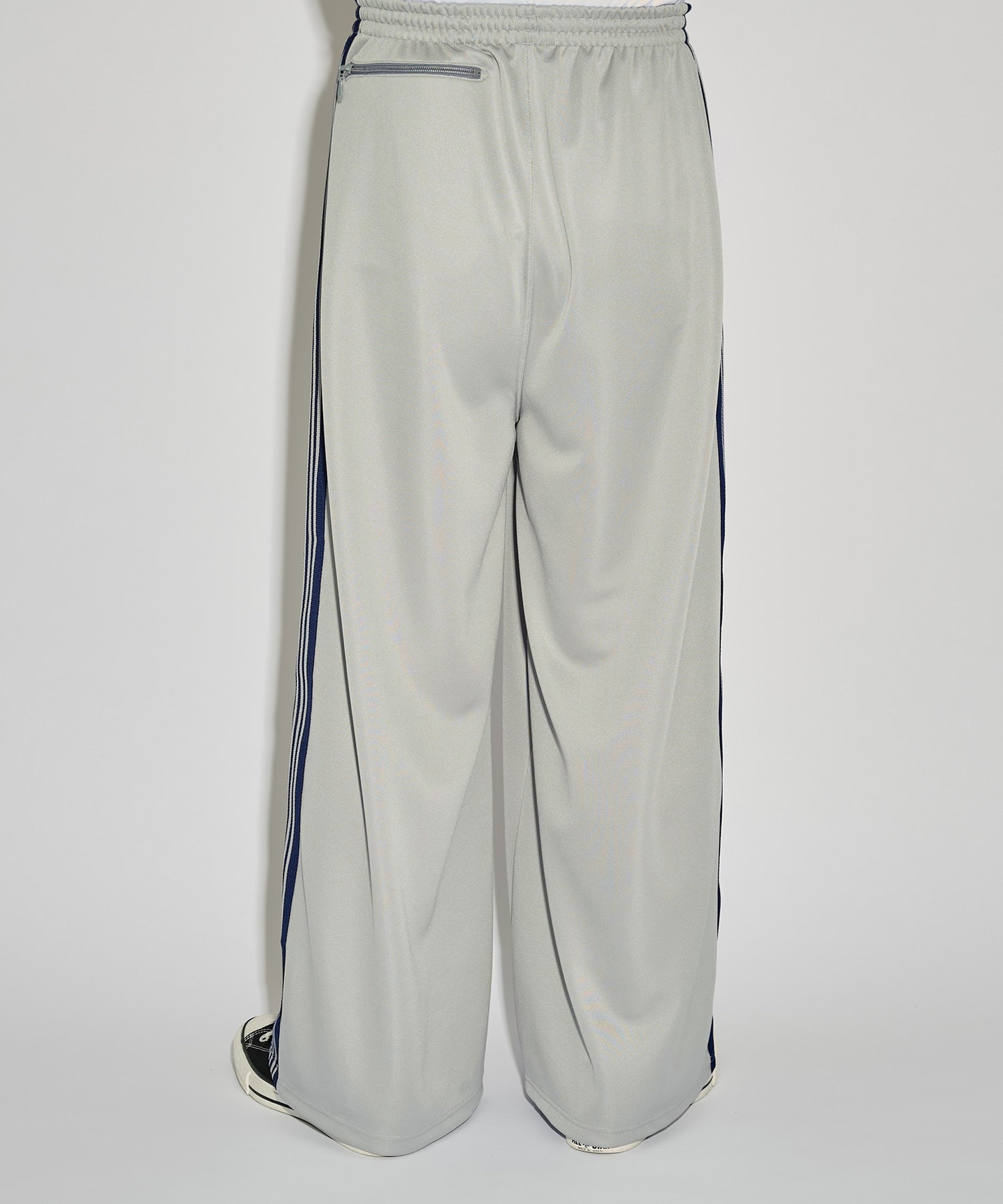 Grey Needles H.D. Track Pant with blue side stripes and butterfly logo, shown from a side angle.