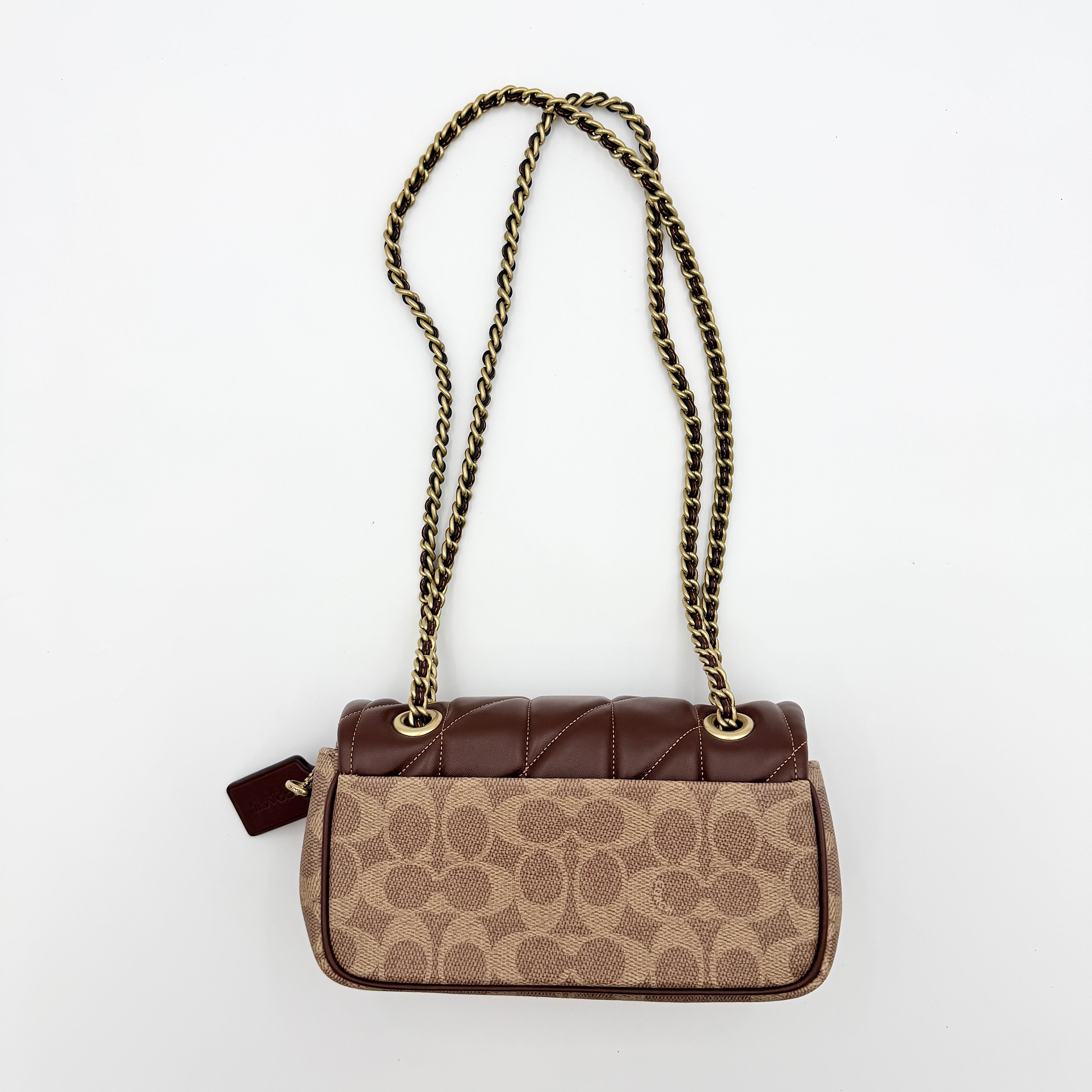 Coach Signature Quilted Tabby Shoulder Bag in brown monogram canvas with gold chain strap and oversized C clasp.