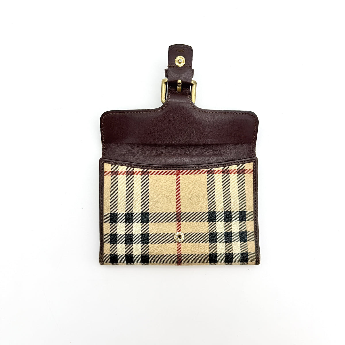 Burberry Nova Check wallet in beige and brown with leather trim and brass buckle detail photographed on white background.